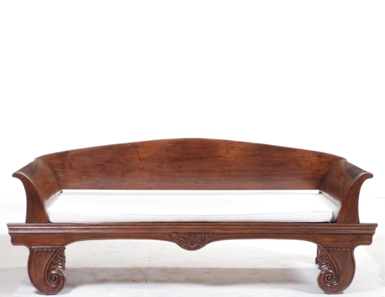 Palatial hand carved and hand finished teak day bed. 96” wide and 38.5” deep size. Can be used indoors as well as outdoors under a covered patio or screened in porch. The 4” thick pad is covered in white canvas. 