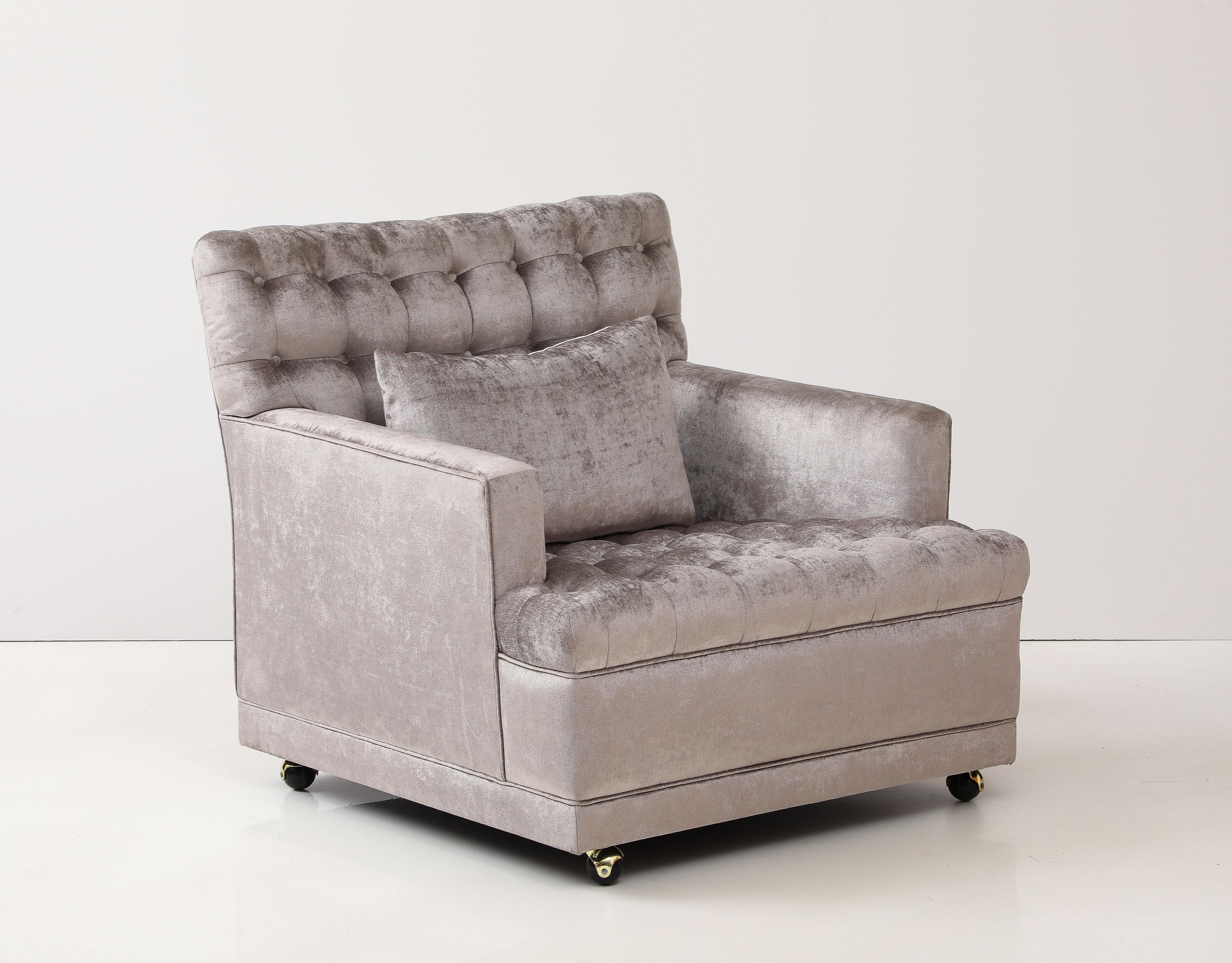 Glamorous 1960's club chair in the style of Billy Haines.
The chair has been beautifully reupholstered in Silvery Grey velvet fabric.
The seat and back of the chair have biscuit tufting and it is on casters for easy movement.
There is a separate