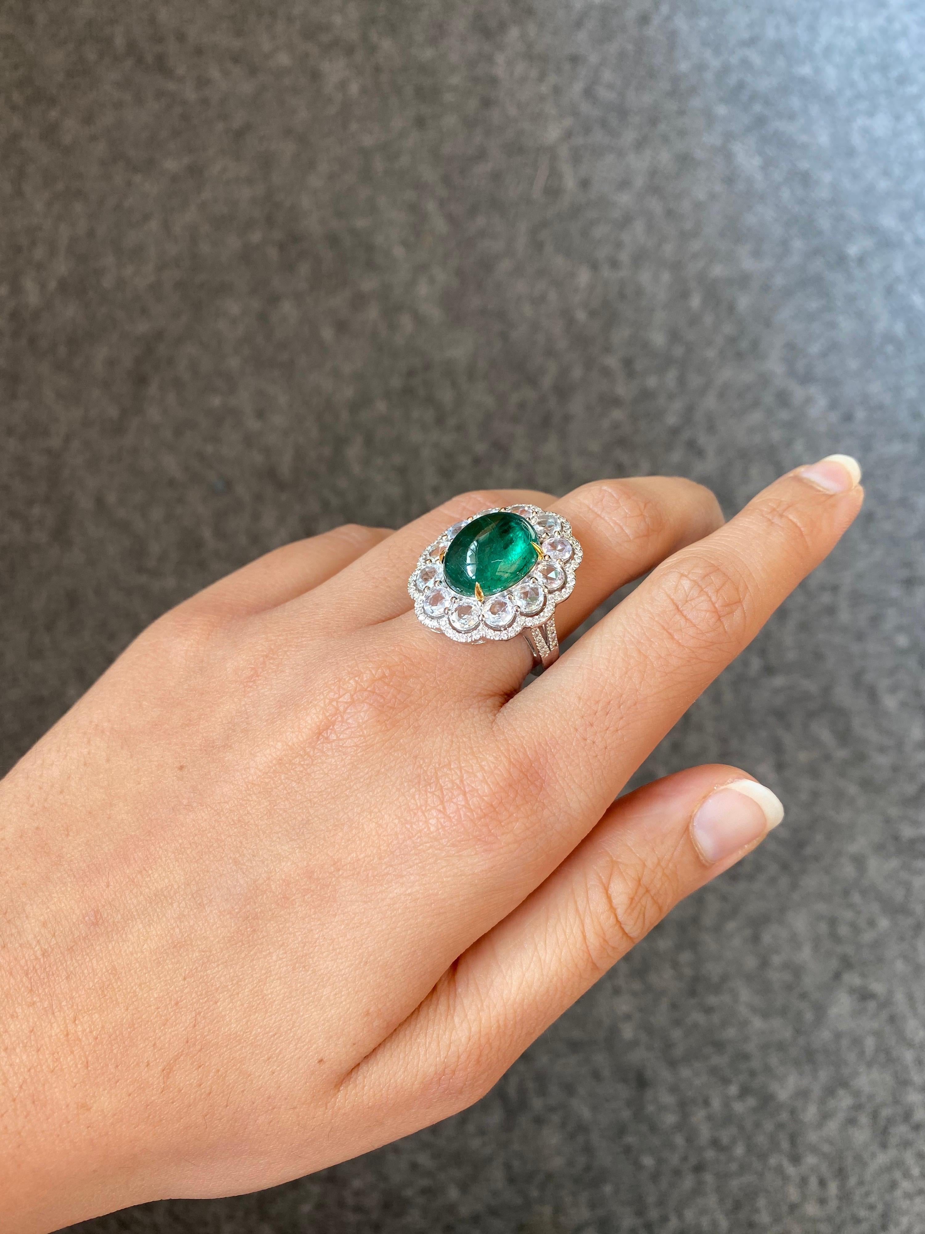 Make a statement when you wear this gorgeous 18K White Gold, natural Emerald and Diamond cocktail engagement ring. The centre stone is an oval cabochon Zambian Emerald of top quality.  It is completely transparent and there is an immense amount of