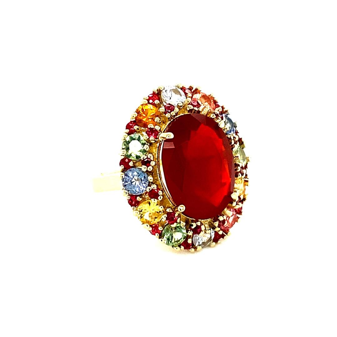9.61 Carat Natural Fire Opal Multi Color Sapphire Yellow Gold Ring

This ring has a Natural Oval Cut Red Fire Opal that weighs 5.70 carats and 12 Natural  Multi Color Sapphires that weigh 3.15 carats.  It is also adorned with 26 Natural Red