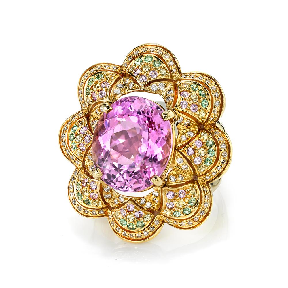 Pastel perfection! This ring has a lovely pastel palette of gemstones, featuring a gorgeous violetish-pink kunzite center stone. Bright green tsavorite garnets, white diamonds, and yellow diamonds are pave set around the kunzite. All gemstones are