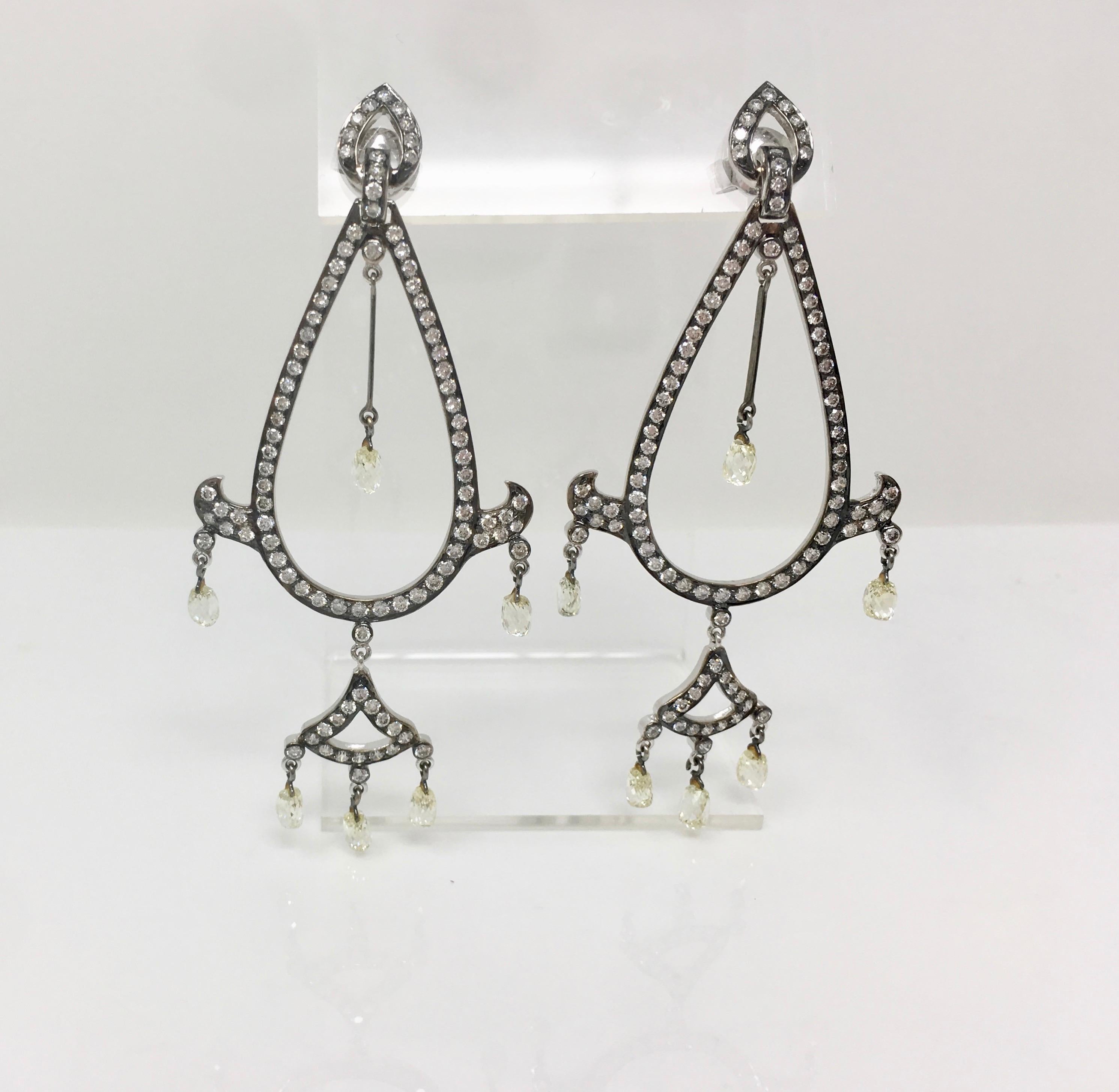 An attractive and eye catching dangle earrings by Moguldiam Inc. High quality white round brilliant and briollette diamond  pop against  the polish black 18k gold.  12 briolette diamond weigh a total of 6 carat with MN color and VS-SI  clarity. The