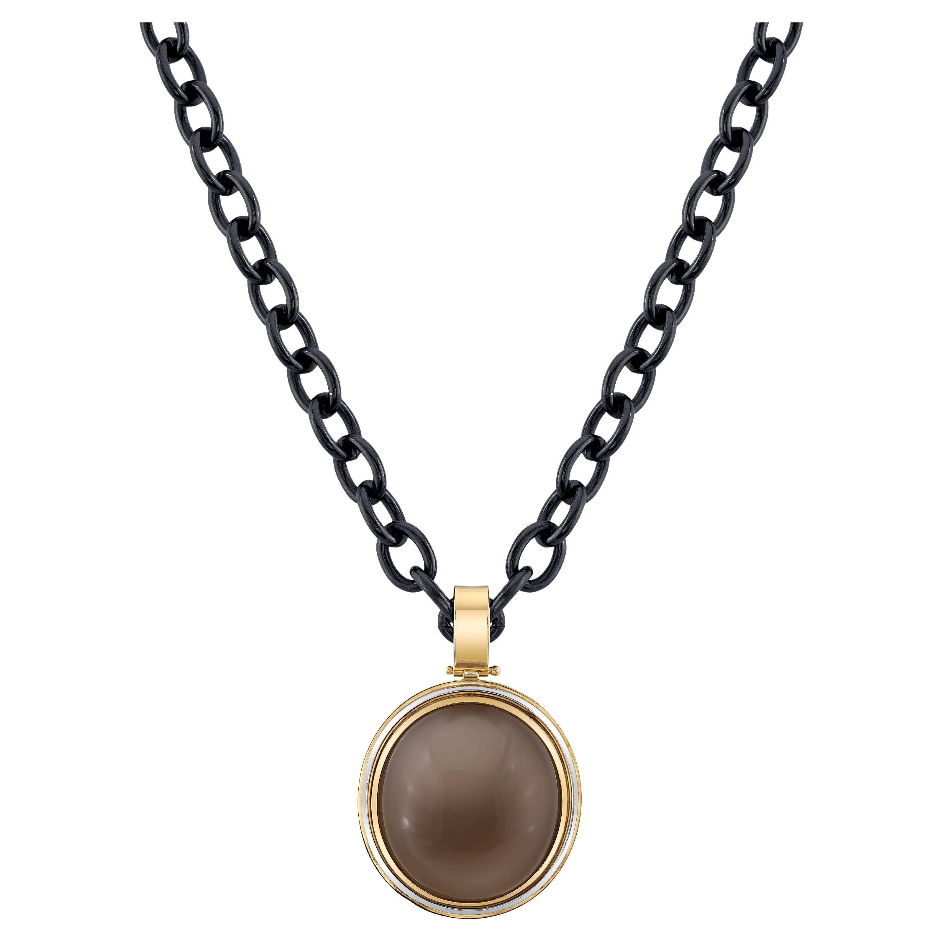 This stunning pendant features an impressive 96.50 carat taupe colored moonstone, bezel set in an 18k yellow gold pendant that was custom made for this gem. The moonstone has a gorgeous soft, grayish taupe color that is very neutral and