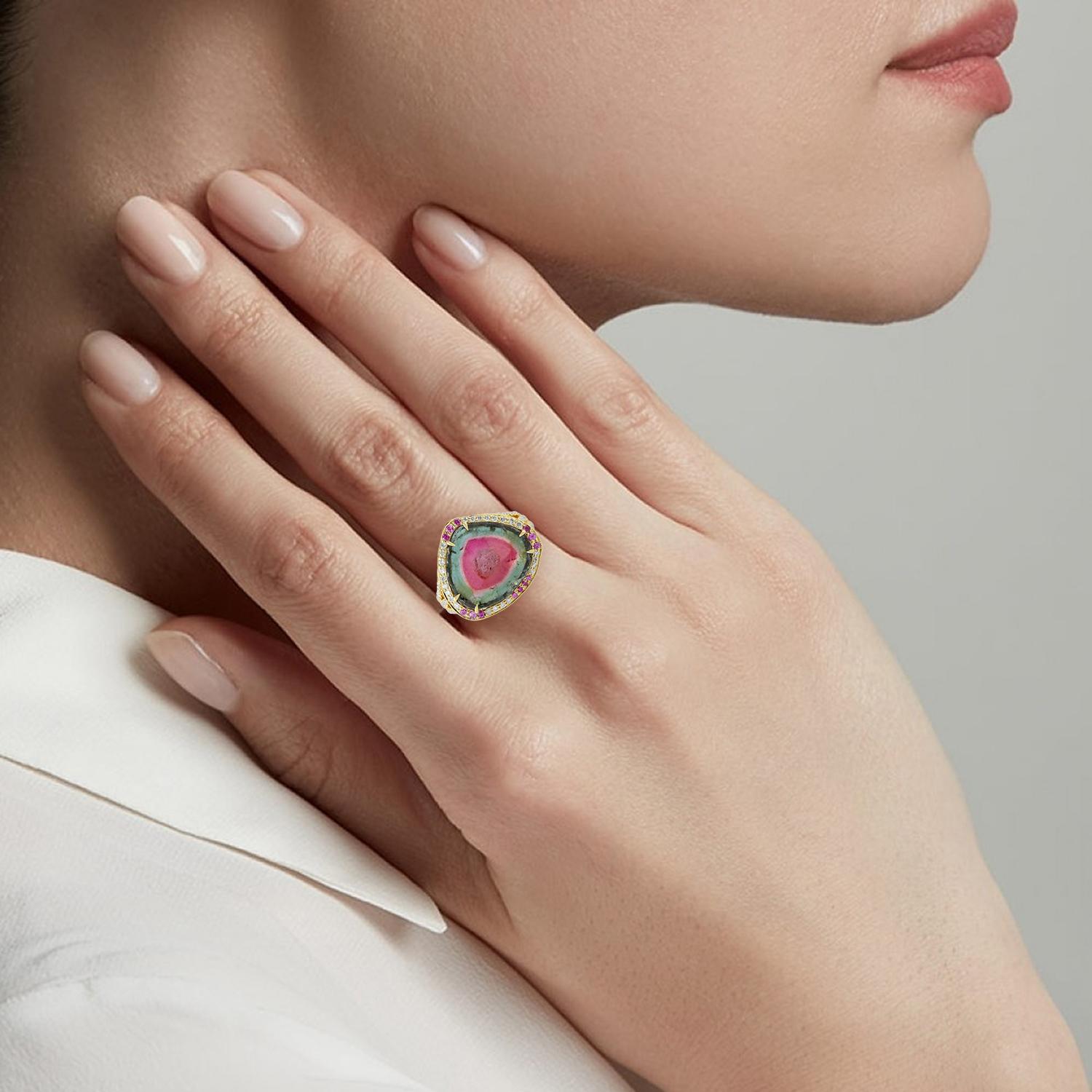 This stunning ring has been meticulously crafted from 18-karat gold. It is hand set in 9.67 carats tourmaline, .17 carats sapphire and illuminated with .54 carats of glittering diamonds. 

The ring is a size 7 and may be resized to larger or smaller