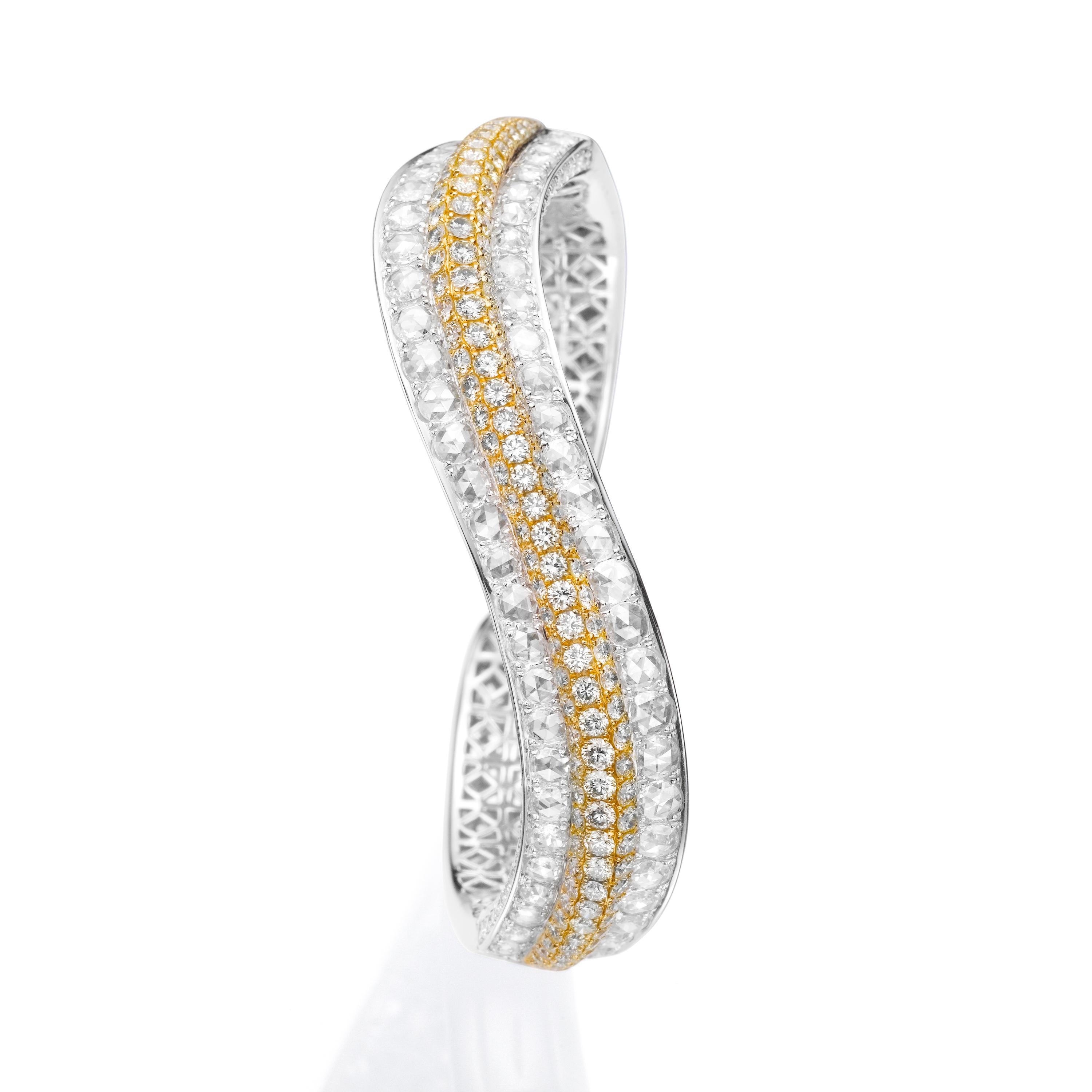 Butani's bangle is decorated with two rows of rose-cut round diamonds (totaling 4.22 carats) and a center row of round yellow diamonds (totaling 4.25 carats).  Set in a wave design and handcrafted from 18 karat gold, the bangle features an open band