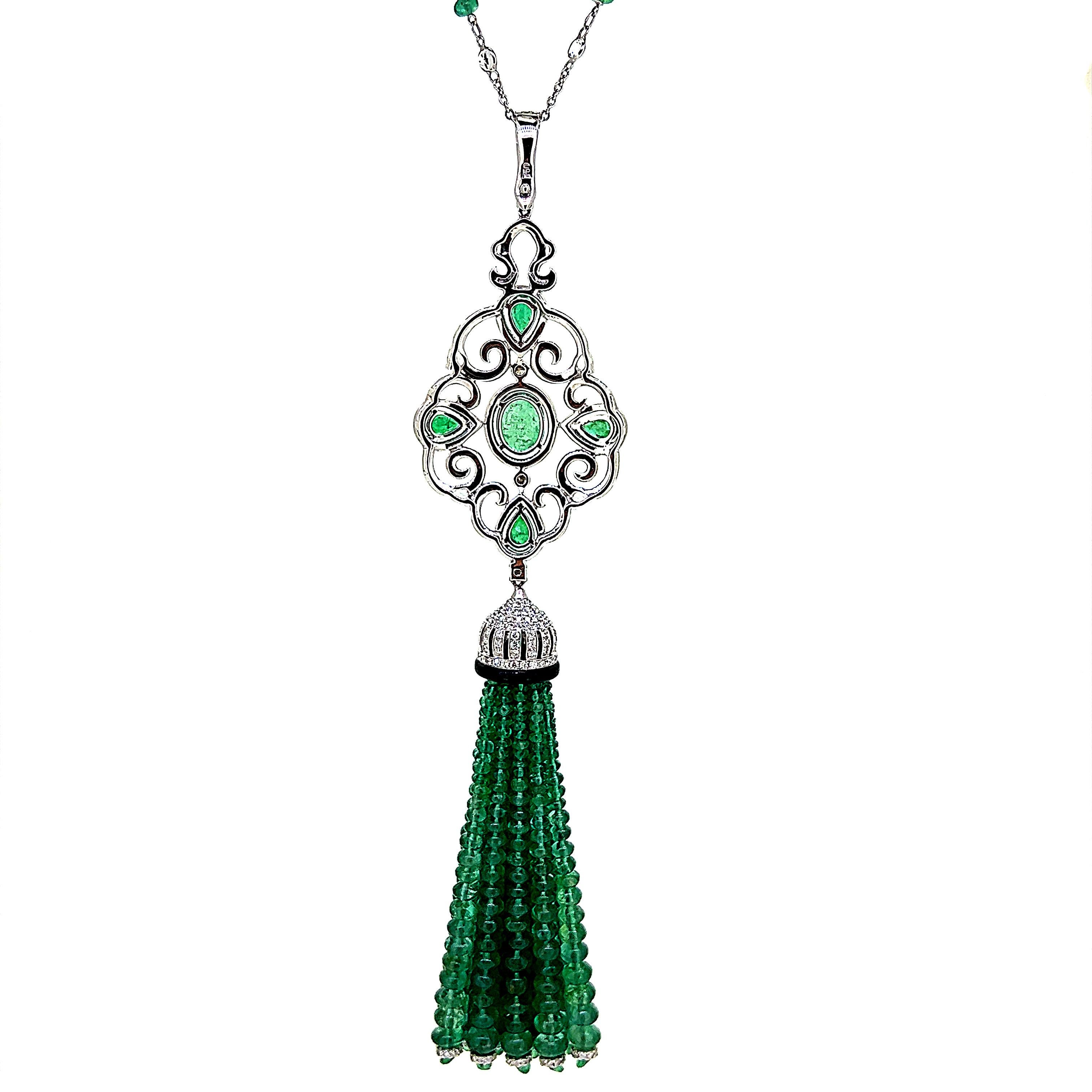 This is a stunning Emerald, Diamond and Onyx Tassel Necklace weighing 96.93 carats in total.  This remarkable piece features glimmering beads with various cut and sizes of emerald and diamonds set on 18 Karat White Gold.  Chain consists of emerald