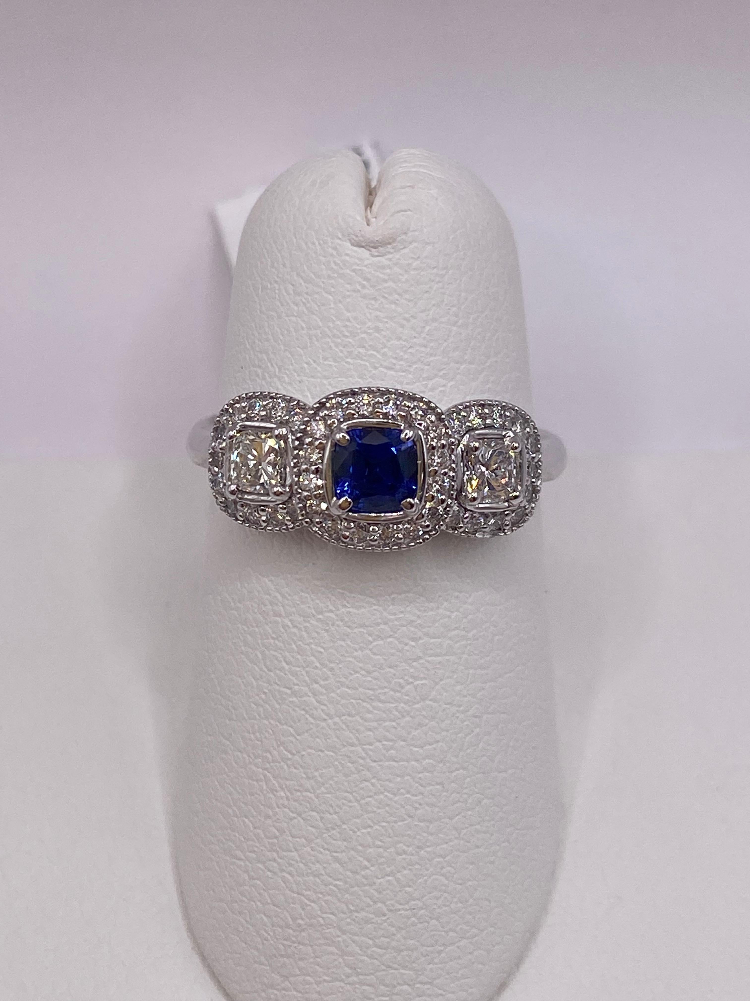 18KT White Gold
Ring Size 6.5
(ring is size 6.5 but is sizable upon request)

Number of Cushion Cut Sapphires: 1
Carat Weight: 0.33ct

Number of Cushion Cut Diamonds: 2
Carat Weight: 0.35ctw

Number of Round Diamonds: 38
Carat Weight: 0.28ctw

This