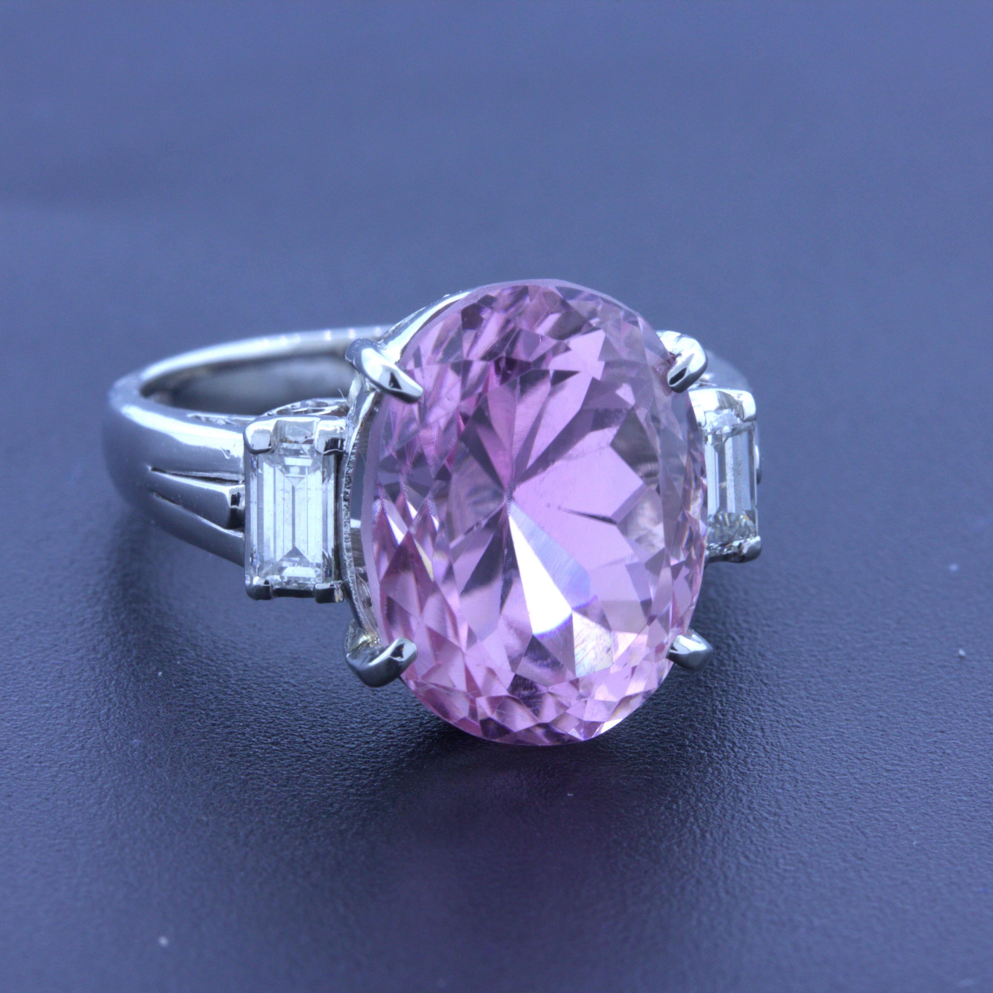 A timeless classic 3-stone platinum ring featuring a fine bright pink kunzite. The kunzite weighs 9.70 carats and glows brightly in the light and is completely clean with no inclusions seen even with a jewelers loupe. It is complemented by two