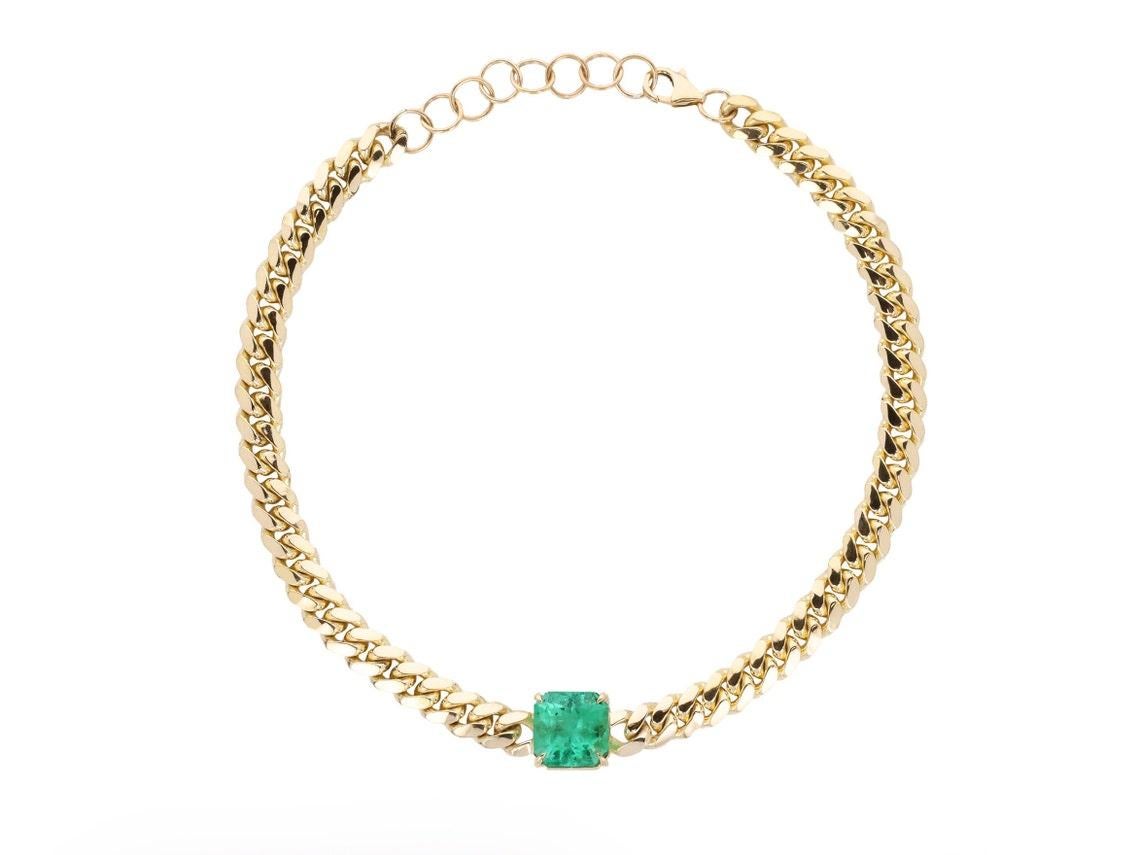 Featured here is a 9.70-carat stunning, emerald choker necklace in 14K yellow gold. Displayed in the center is a natural emerald Colombian emerald accented by a simple prong setting, allowing for the emerald to be shown in full view. The earth-mined