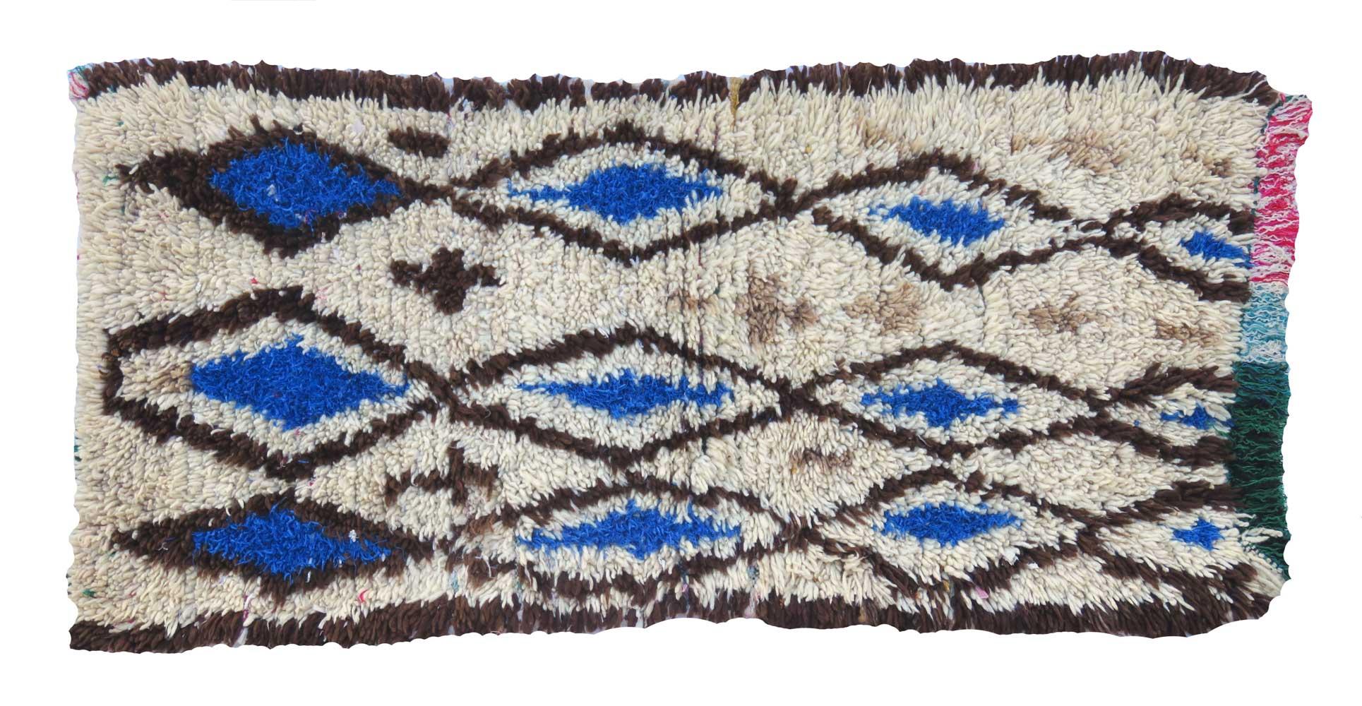 Circa 1970 Azilal runner handwoven with ivory, blue, and brown high pile wool in an abstract diamond Berber design and multi colored fringe .
Dimensions: 2'6 x 5'