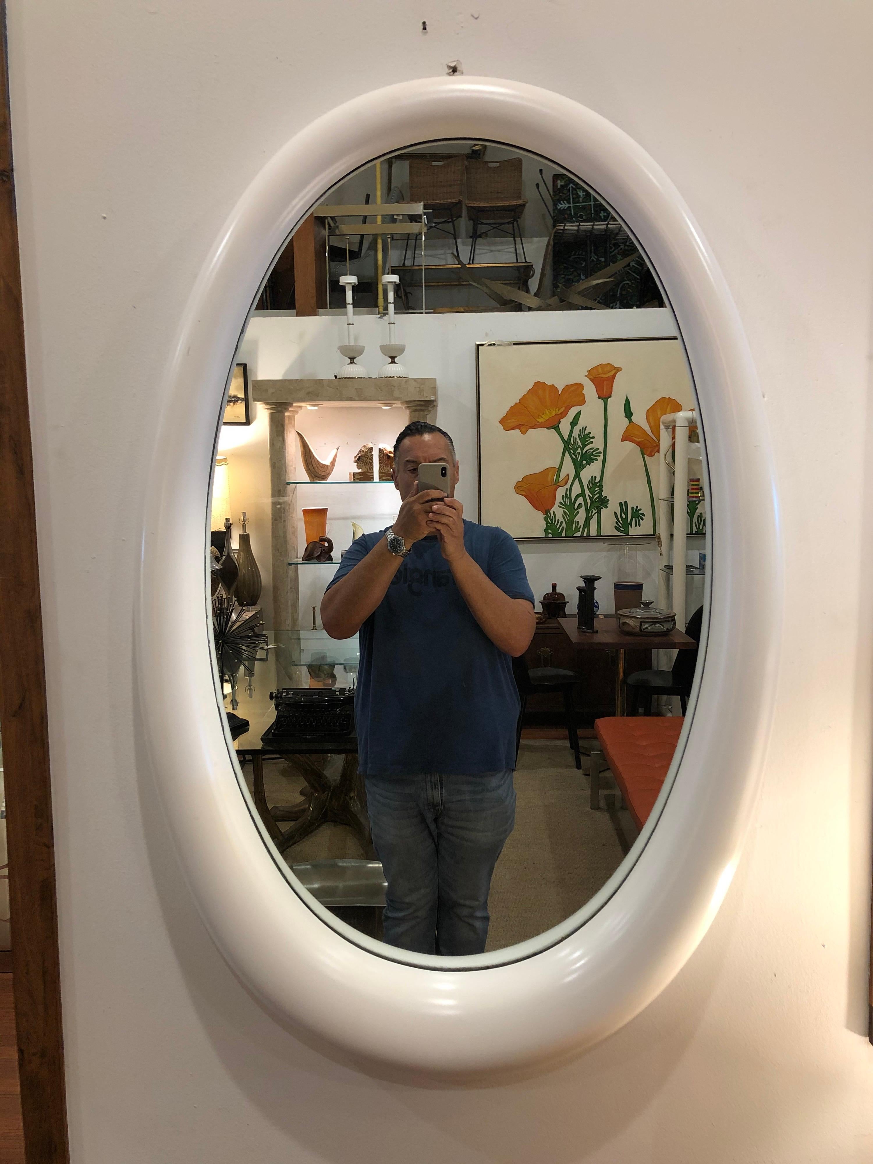 This is a beautiful large oval mirror, circa 1970s freshly relacquer in white nice shape fat at the bottom, no chips or cracks.