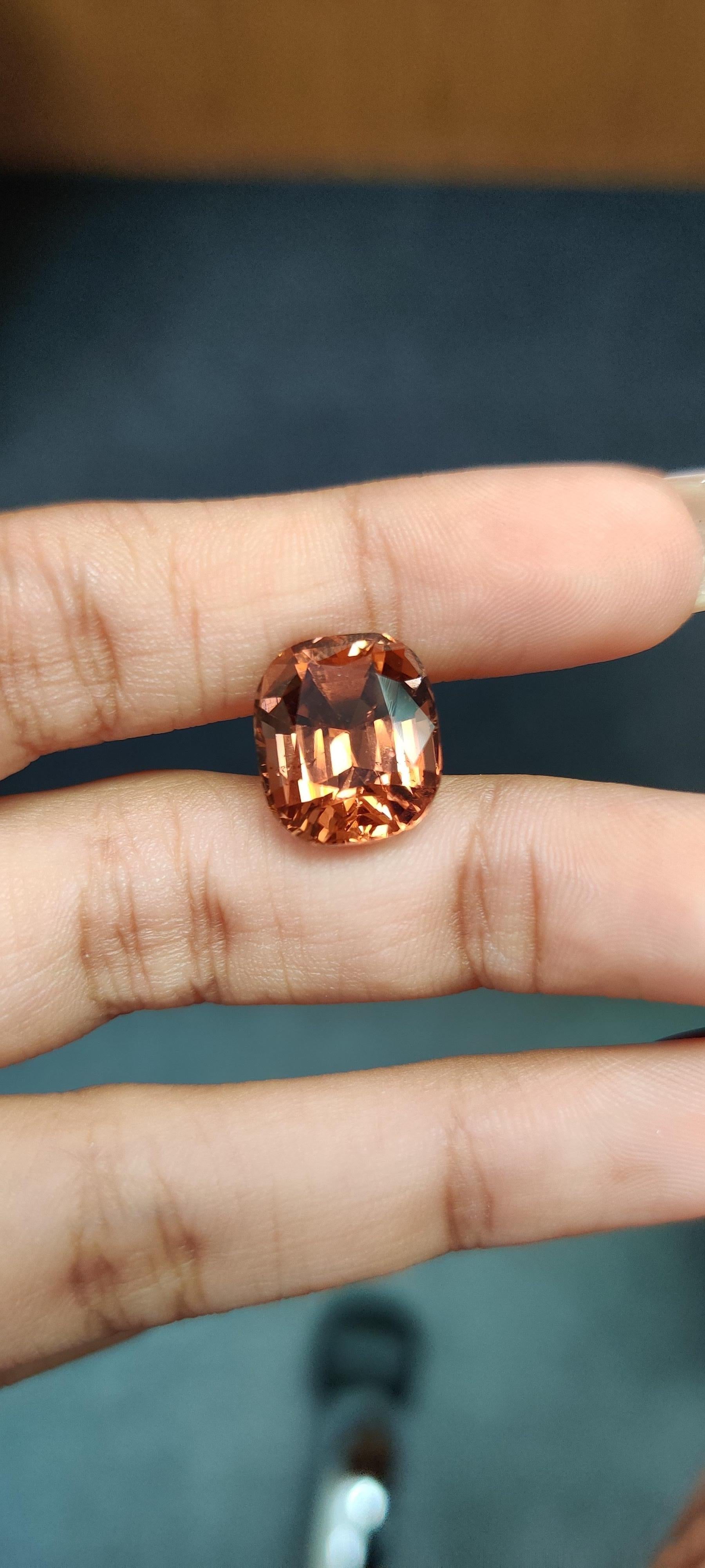 A massive, mesmerizing 9.71 Carat Tourmaline stone that is a gorgeous shade of orange. It is completely natural and of good quality. The tourmaline piece is cut into perfection in a cushion-cut shape.

The orange tourmaline has not undergone any