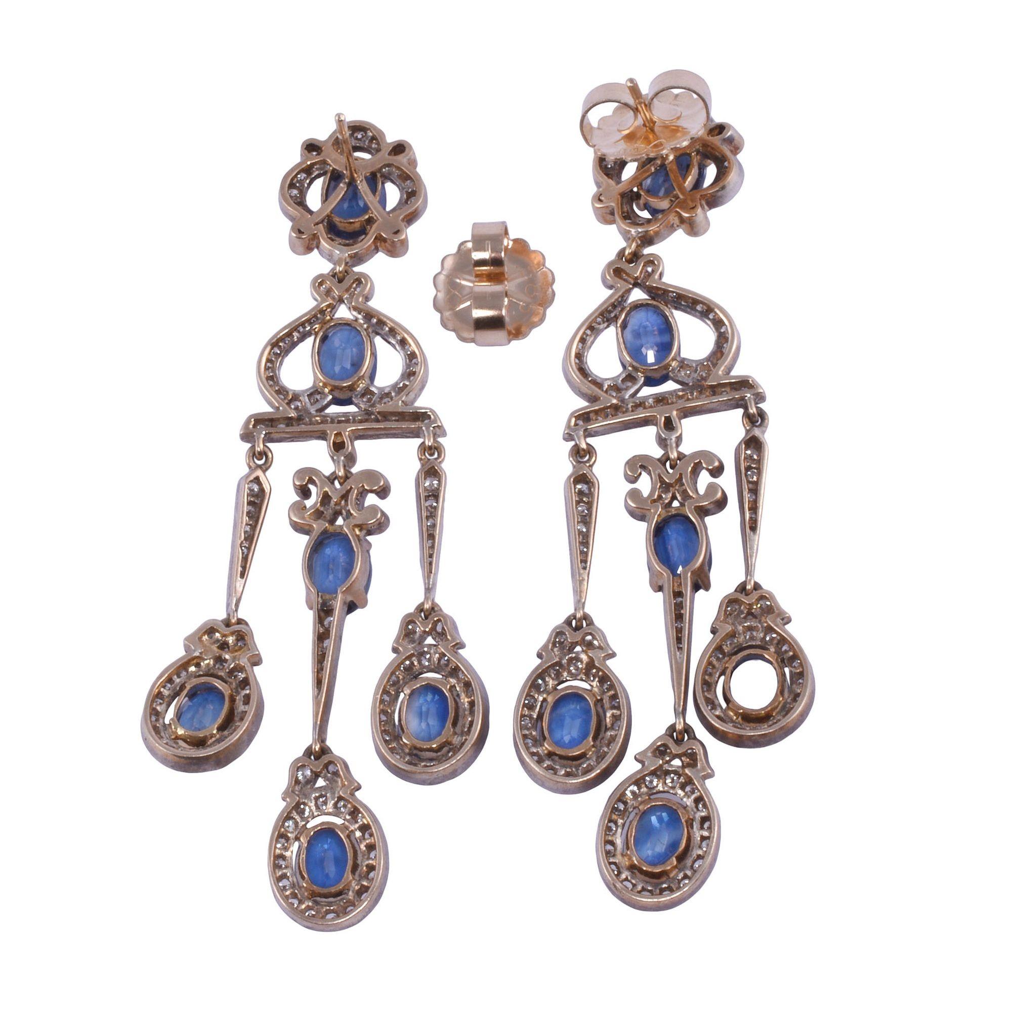 Vintage 9.71 CTW sapphire & diamond girandole dangle earrings. These Victorian style vintage earrings are crafted in 18 karat yellow gold topped with silver. They feature 9.71 CTW of oval sapphires that are very well matched, eye clean, and have