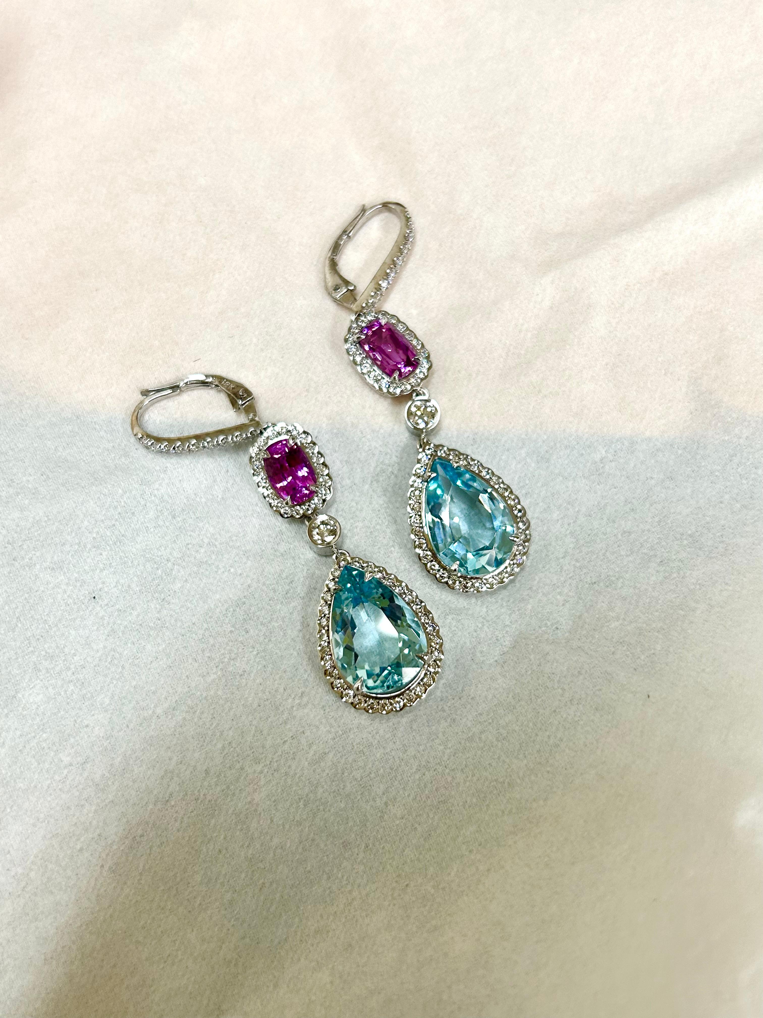 18K white gold earrings, featuring two glistening Aquamarines weighing 9.71 carats, paired with two dazzling Pink Sapphires weighing 2.83 carats, encrusted with a total of 1.32 carats of sparkling white diamonds.