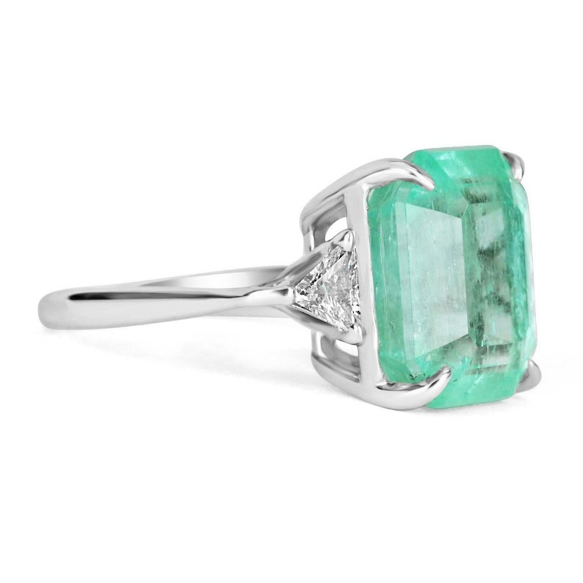 A classic Colombian emerald and diamond engagement, statement, or right-hand ring. Dexterously crafted in gleaming 18K gold this ring features a 9.01-carat natural Colombian emerald-emerald cut from the famous Chivor mines. Set in a secure prong