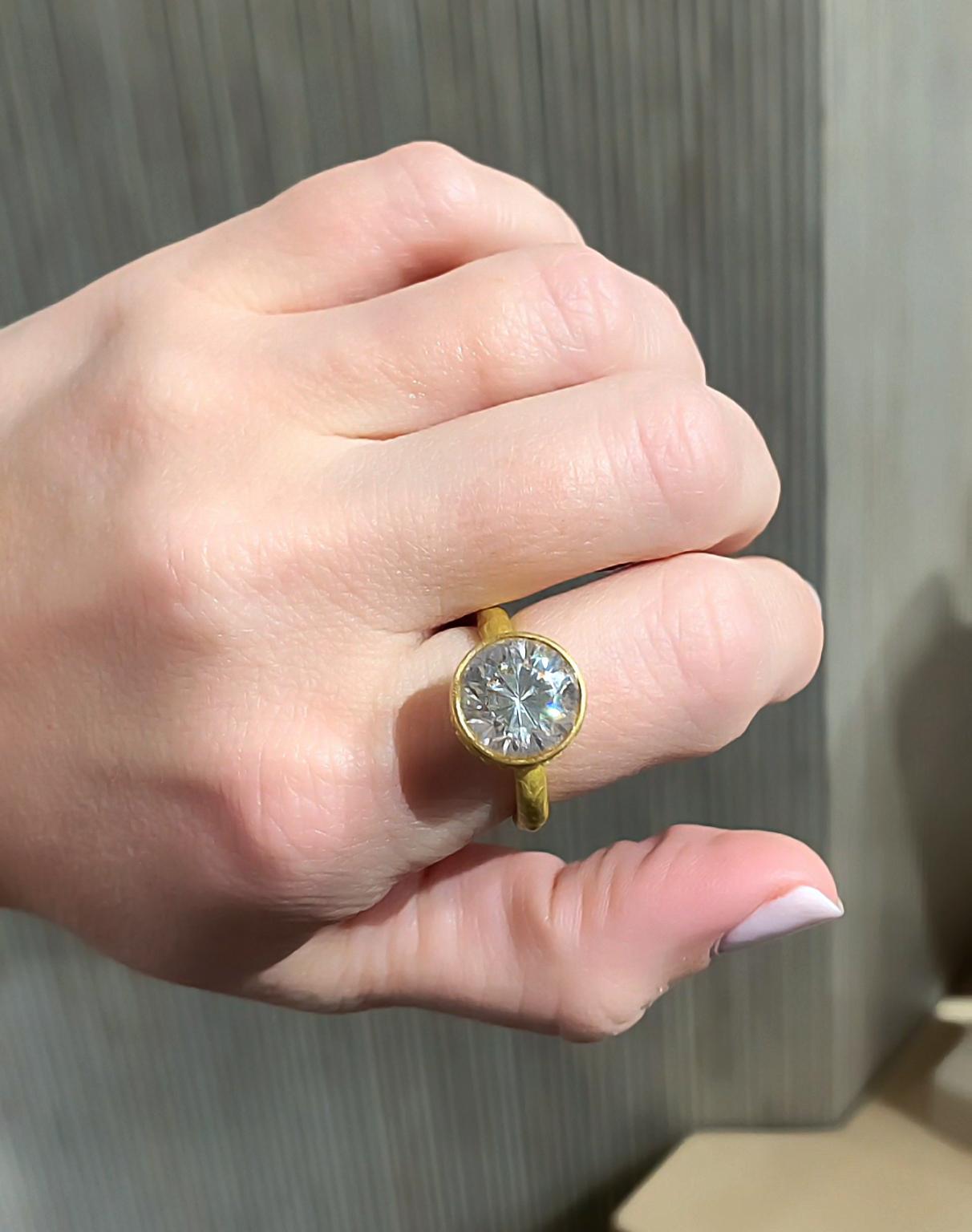 One of a Kind Ring hand-fabricated in Belgium by award-winning jewelry maker Eva Steinberg showcasing a stunning, completely natural 9.72 carat round brilliant white zircon with vivid fire and refraction, set in 21k yellow gold and embellished with