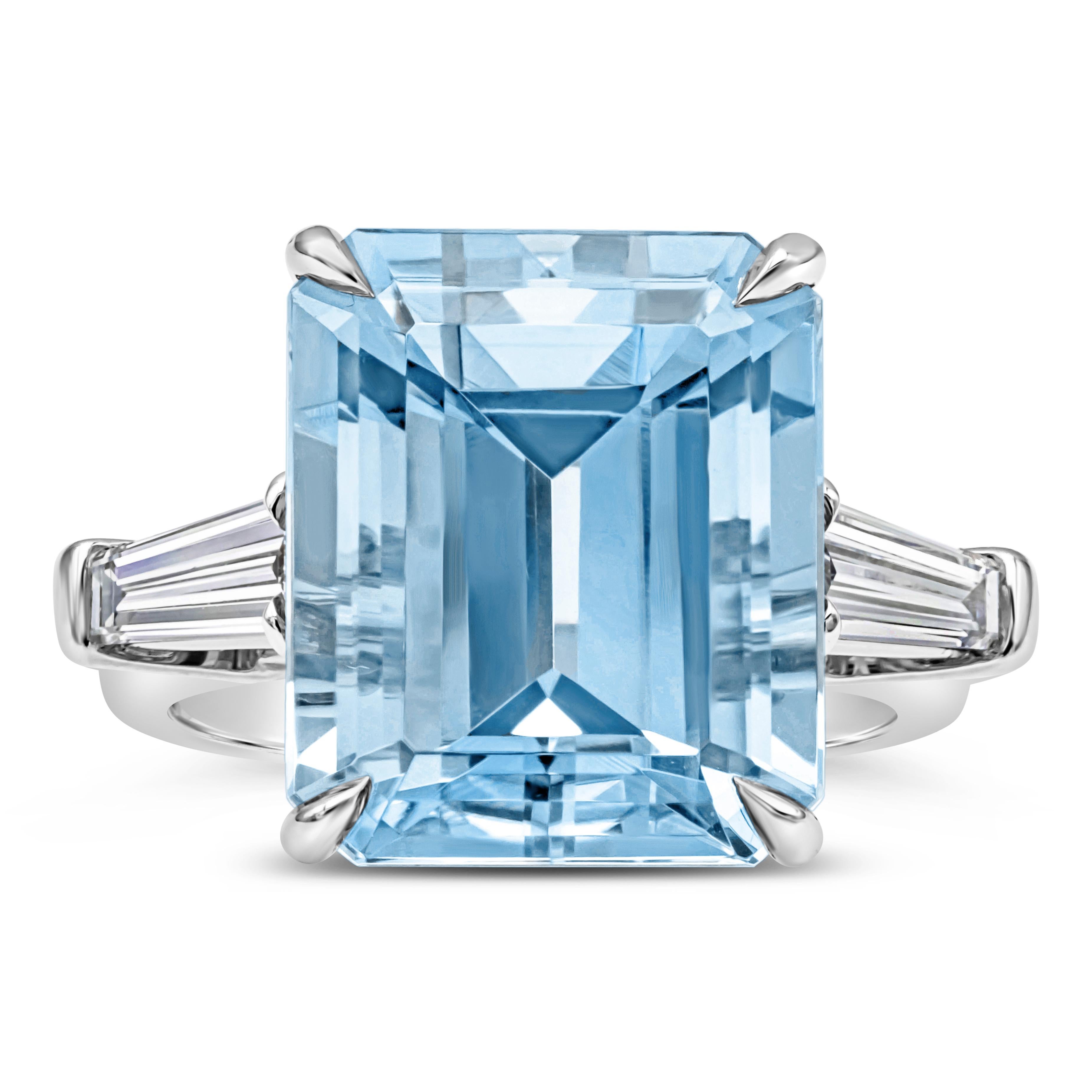 This gorgeous and sleek three stone engagement ring features a 9.73 carats emerald cut Santa-Maria blue aquamarine in the center. Flanked by two GIA certified brilliant baguette cut diamonds on each side weighing 0.78 carats total, E Color and