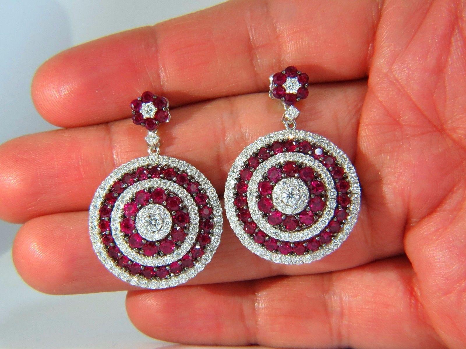 Bulls Eye / Roulette / Circular Raised Dome

Ruby Diamonds Dangling Earrings & Cluster top

7.50ct. Natural Red Rubies.

Rubies: Rounds, Full Cuts.

Transparent, clean clarity & even red tone.

2.24cts of round diamonds: 

G-color, Vs-2