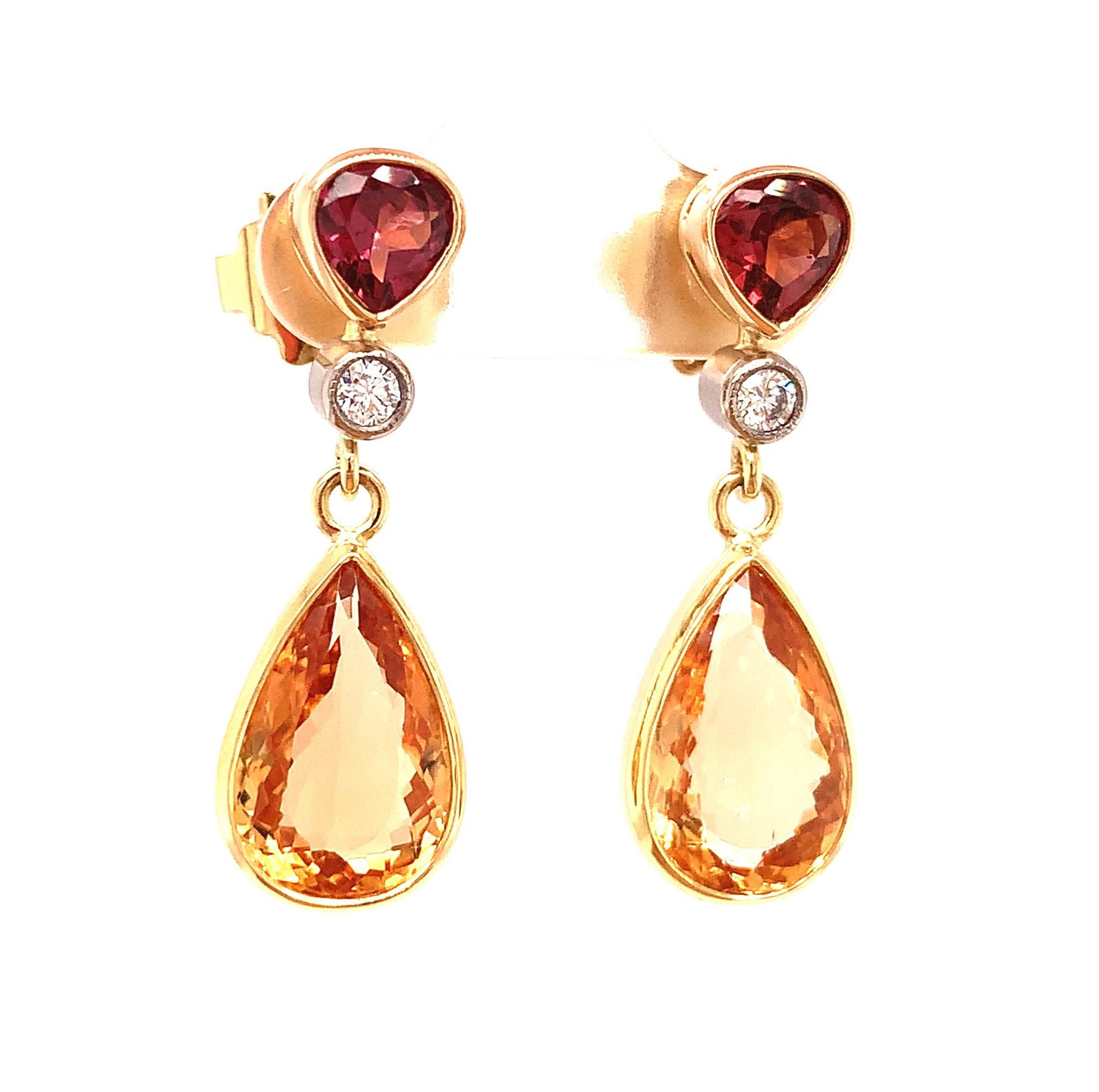 The beauty of these red and gold dangle earrings is undeniable! Fine quality precious topazes and mulberry colored garnets update this classic style with a unique pairing of shapes and colors. Matched pairs of precious topaz are seldom seen in this