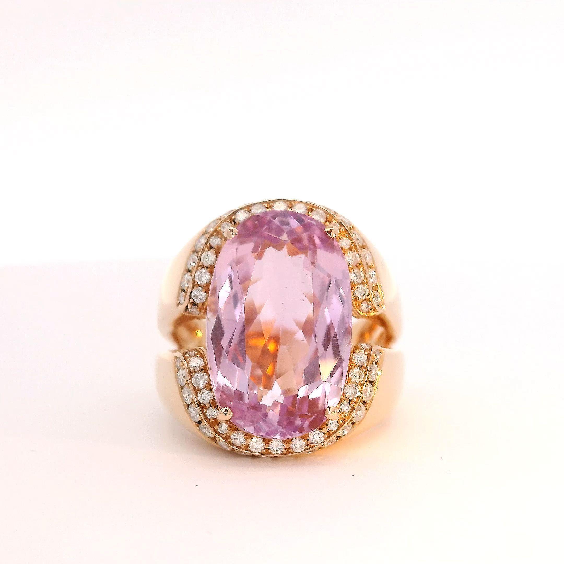 This striking ring emanates beauty through balance of color and form. At its heart rests a captivating 9.75 carat oval-cut pink Kunzite, nature's splendour magnified through skilled facetwork. Around it glistens nearly a full carat of white