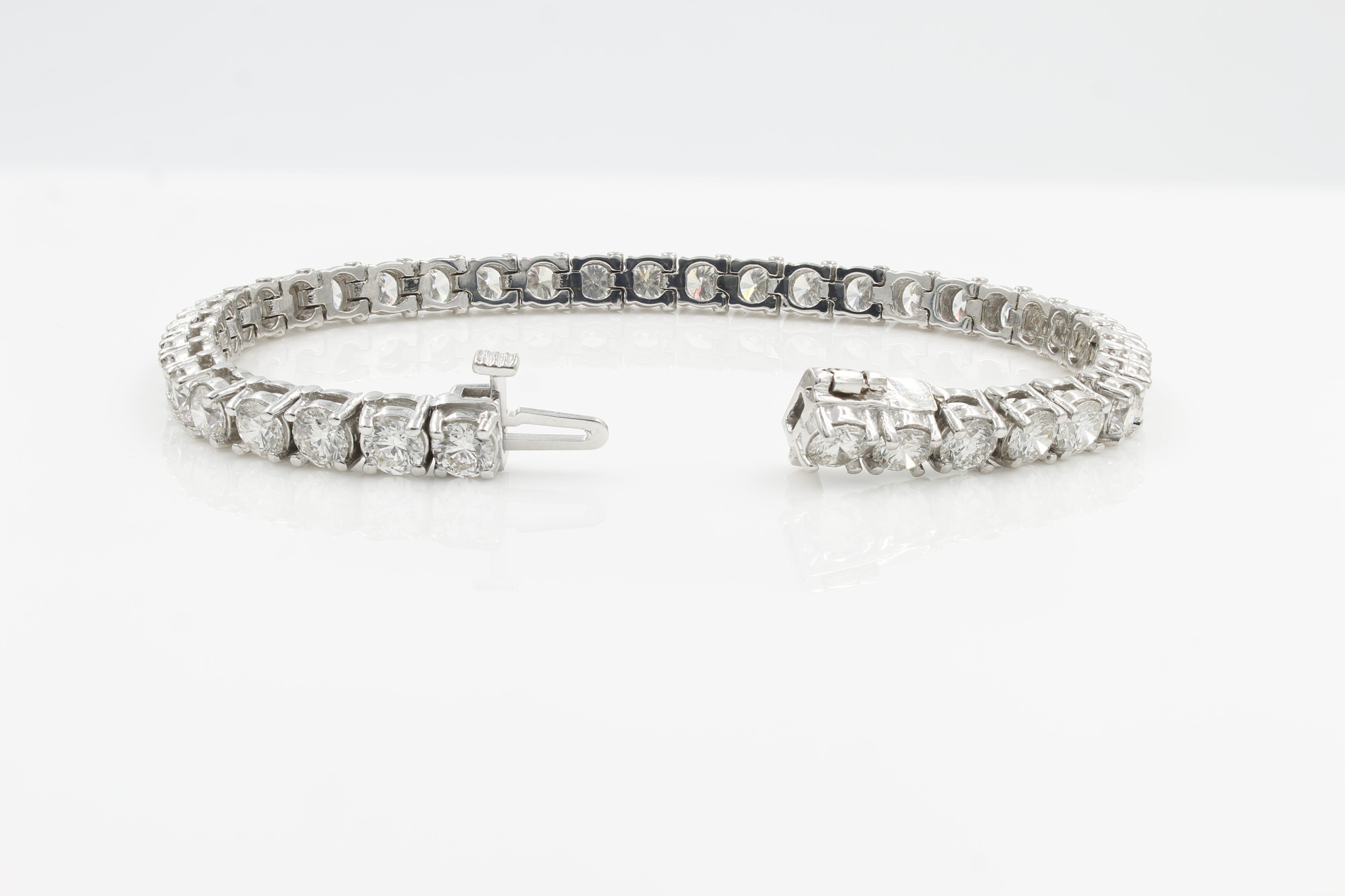 Classic Diamond Tennis Bracelet. This stunning diamond bracelet is set with thirty-nine striking brilliant cut diamonds weighing a total carat weight of 9.75ct. Hallmarked 14K white gold four prong setting with safety clasp and measures 7 inches in