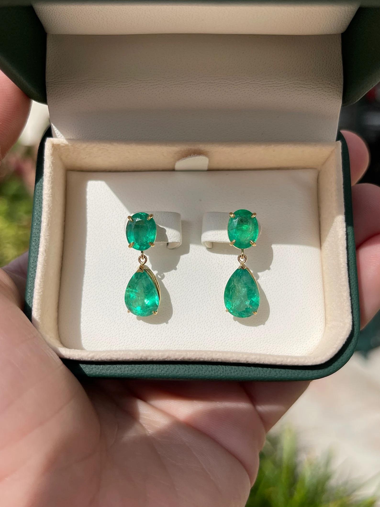 Drool over these fascinating natural vivid dark green emerald oval and pear dangle earrings in solid 18K. Two stunning oval-cut emeralds weighing 3.76tcw showcase a lustrous rich dark green color, accented by large 6.02tcw teardrop emeralds that