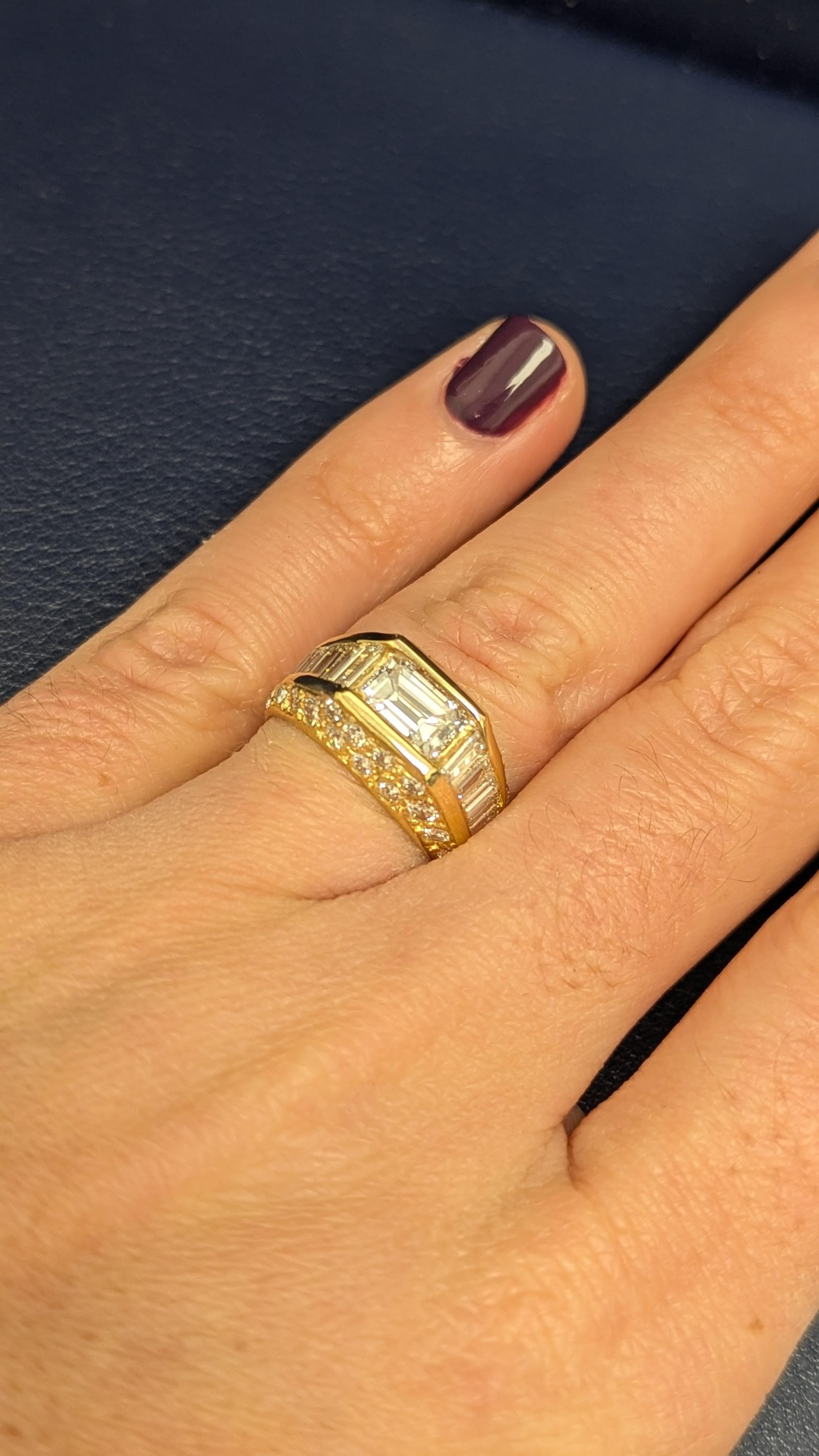 This beautiful ring features a centering emerald-cut diamond, weighing 0.97 cts., set in between channel-set diamond baguette shoulders and full-cut diamonds. 