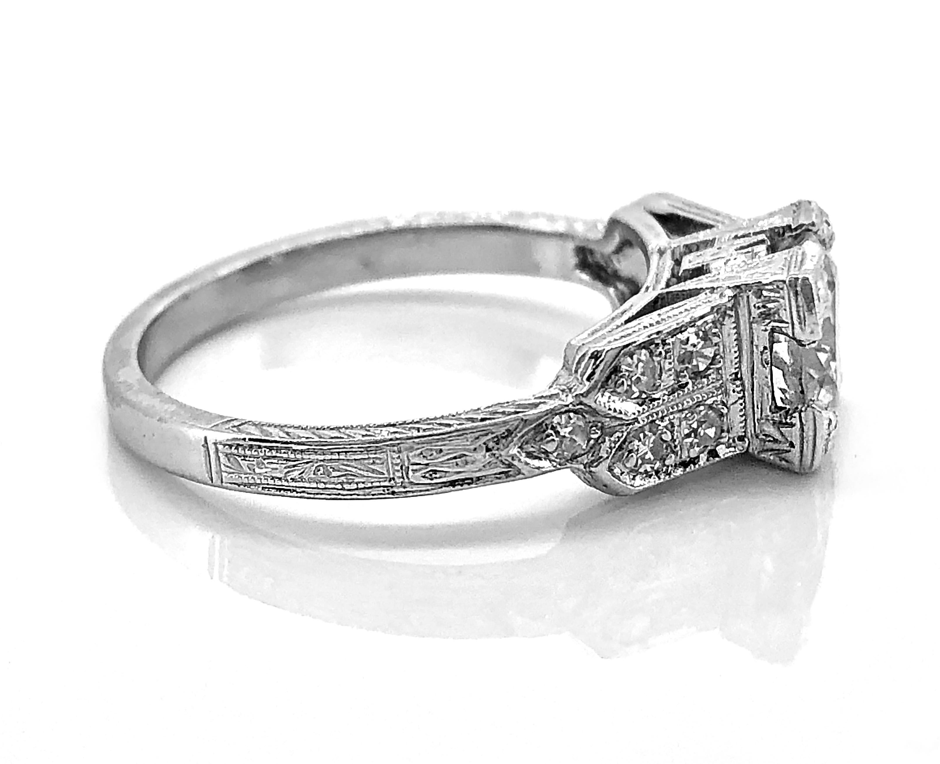 An extraordinary Art Deco diamond Antique engagement ring that features a Transitional cut diamond weighing .98ct. Apx. with SI1 clarity and G color. The accenting single cut diamonds weigh .20ct. Apx. T.W. with VS-SI clarity and G-H color and