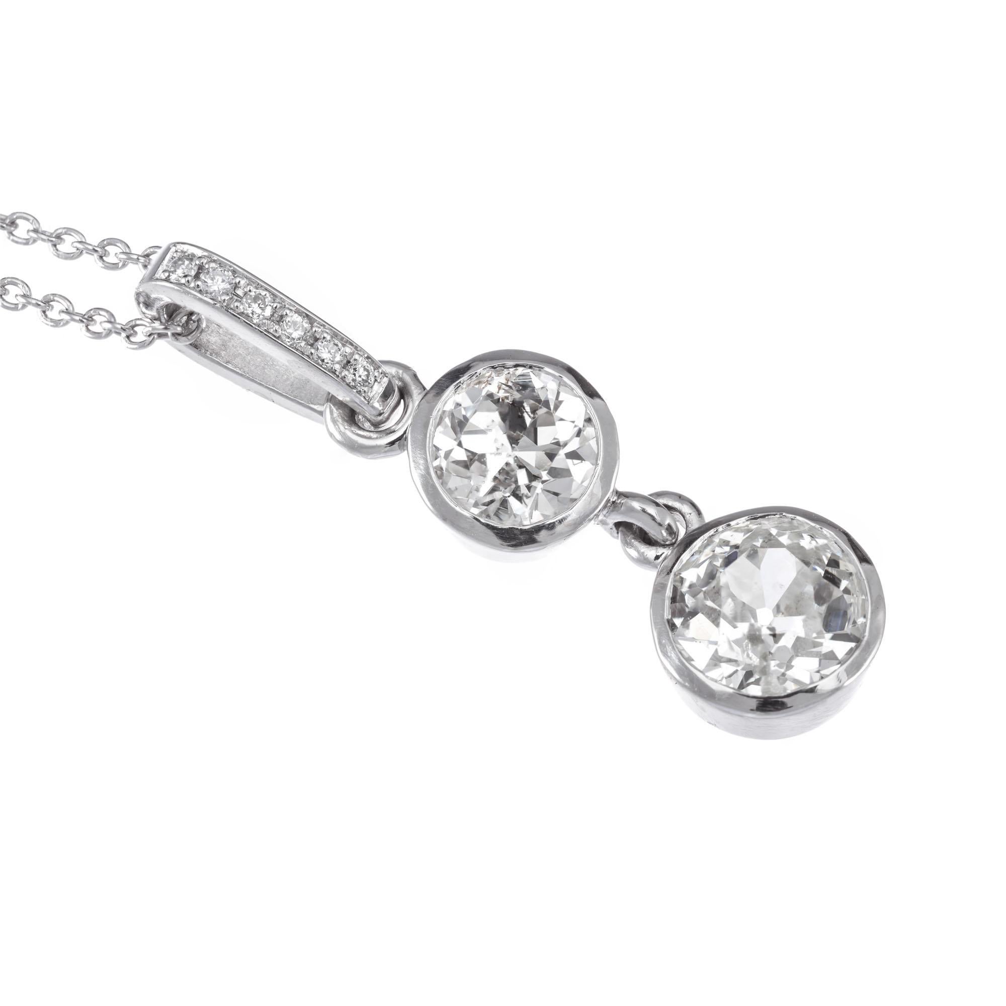 Old European double diamond dangle pendant necklace, with 6 round accent diamonds set in platinum.

1 old European cut K-L I, approx. .55ct
1 old European cut K I, approx. .35ct
6 round brilliant cut diamonds H SI, approx. .3ct
Platinum 
Stamped: