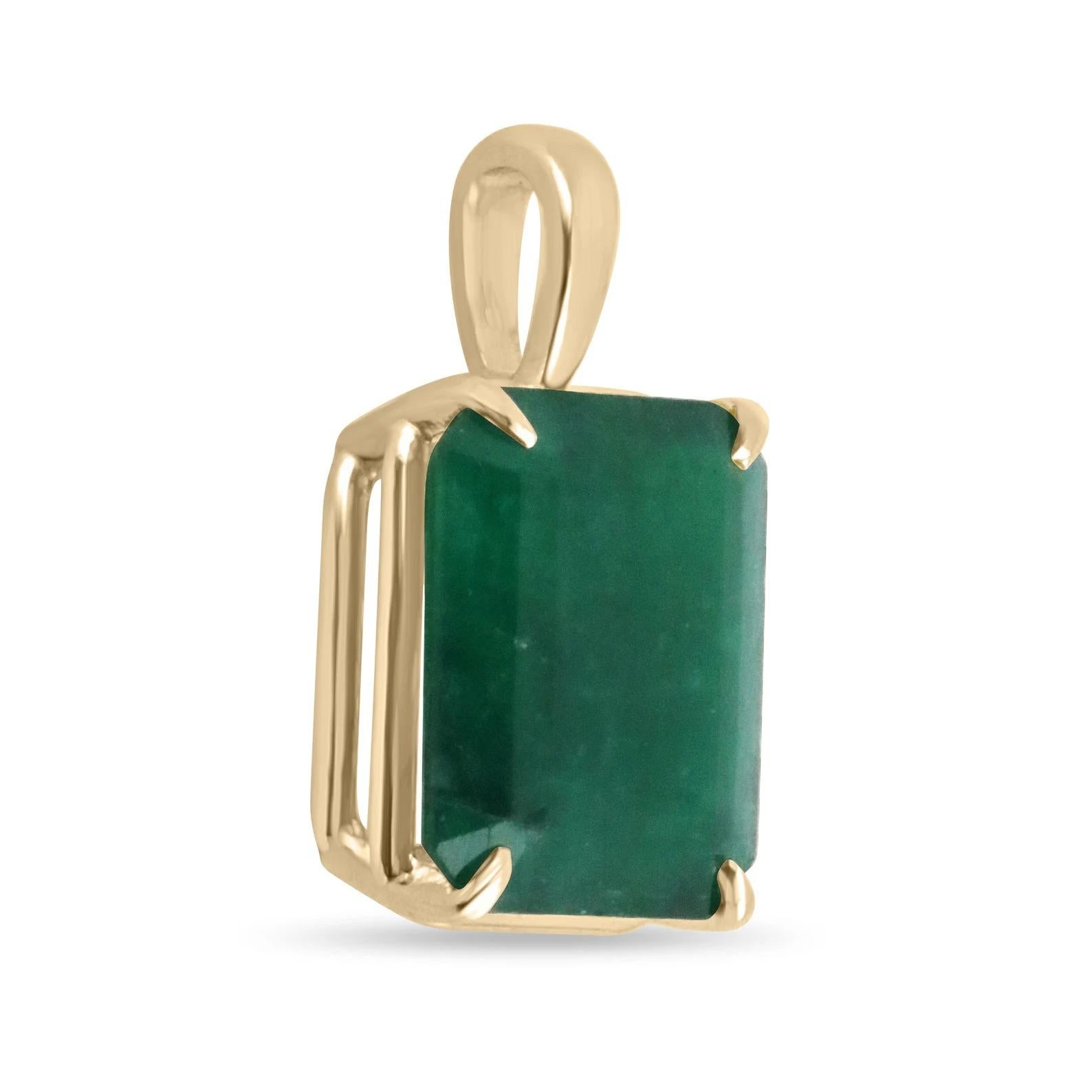 Displayed is a classic super rare huge dark green emerald solitaire necklace set in 14K yellow gold. This gorgeous solitaire pendant carries a large one-of-a-kind 9.80-carat emerald in a four-prong setting. The gem has a dark green color and a very