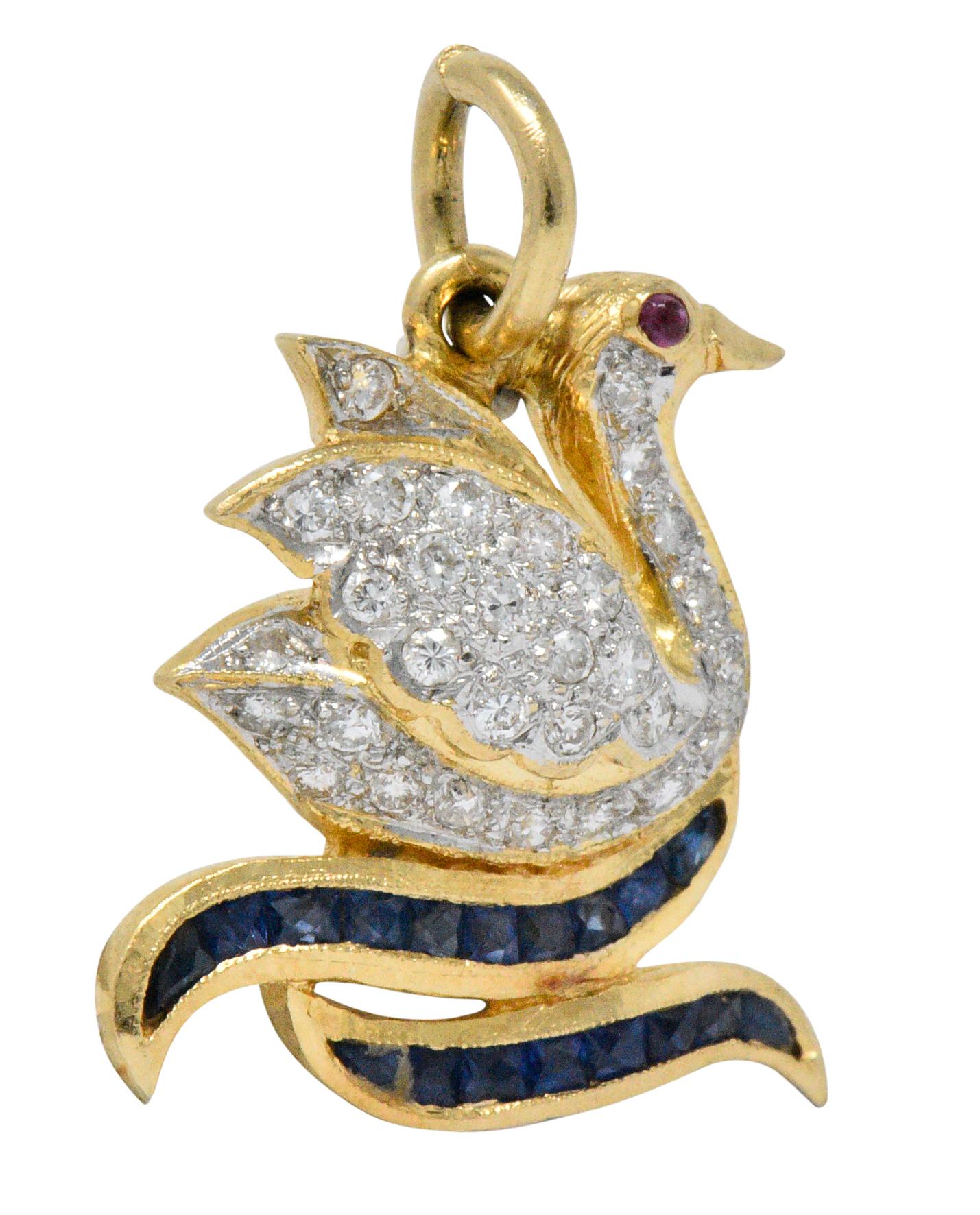 Designed as a swan on the water with pavé set round brilliant cut diamonds, weighing approximately 0.40 carat total, eye-clean and white
Accented by channel set calibré cut sapphire 'waves' and tiny round cabochon ruby eye

Tested as 18 karat