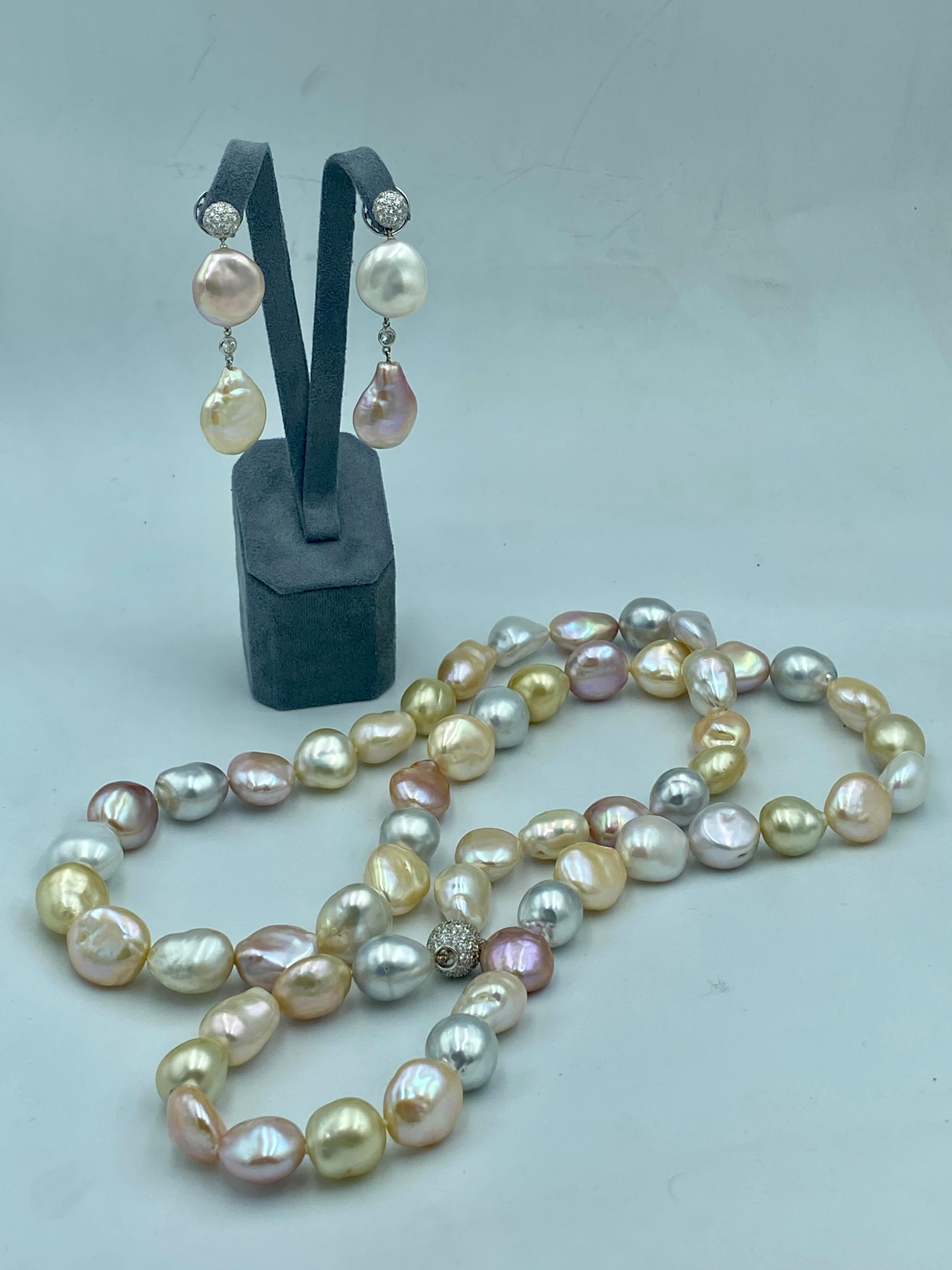This delightful set of pearl earrings and necklace made by the renowned Swiss jeweller Adler in 1980s consists of beautiful pastel hues of yellows, pinks, oranges and greys. The necklace consists of 55 pearls ranging in size from 15-17mm in