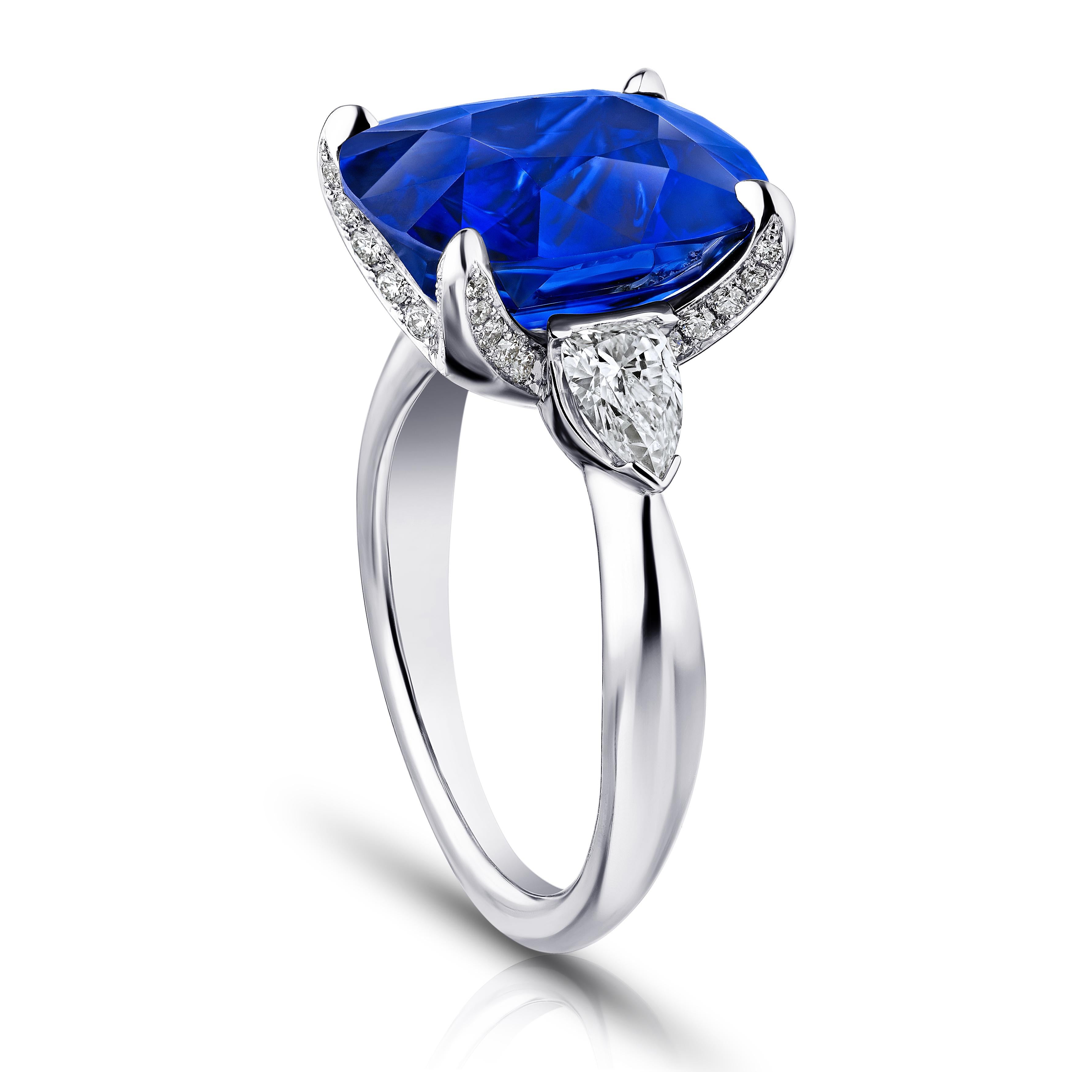 9.81 carat cushion blue sapphire with arrow shaped diamonds .67 carats set in a platinum ring. Size 7. Free resizing to your finger size. This ring is breathtaking. The center stone has a huge look. Its totally clean and has excellent color