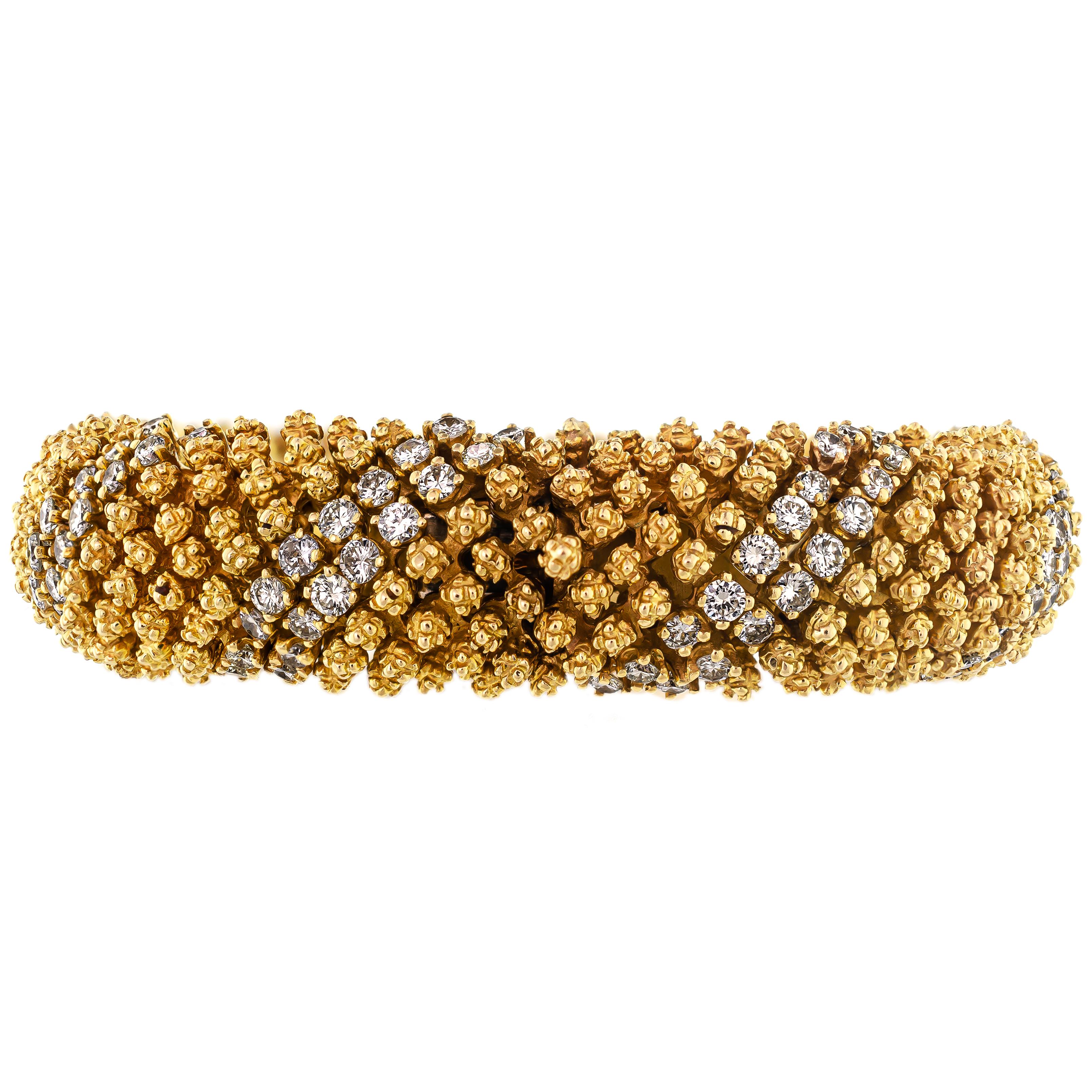 This fashionable diamond and 18 karat yellow gold Circa 1960s flexible gold and diamond bracelet is both artfully and meticulously crafted. The construction of this retro link bracelet is simply fascinating. Designed out of three-dimensional little