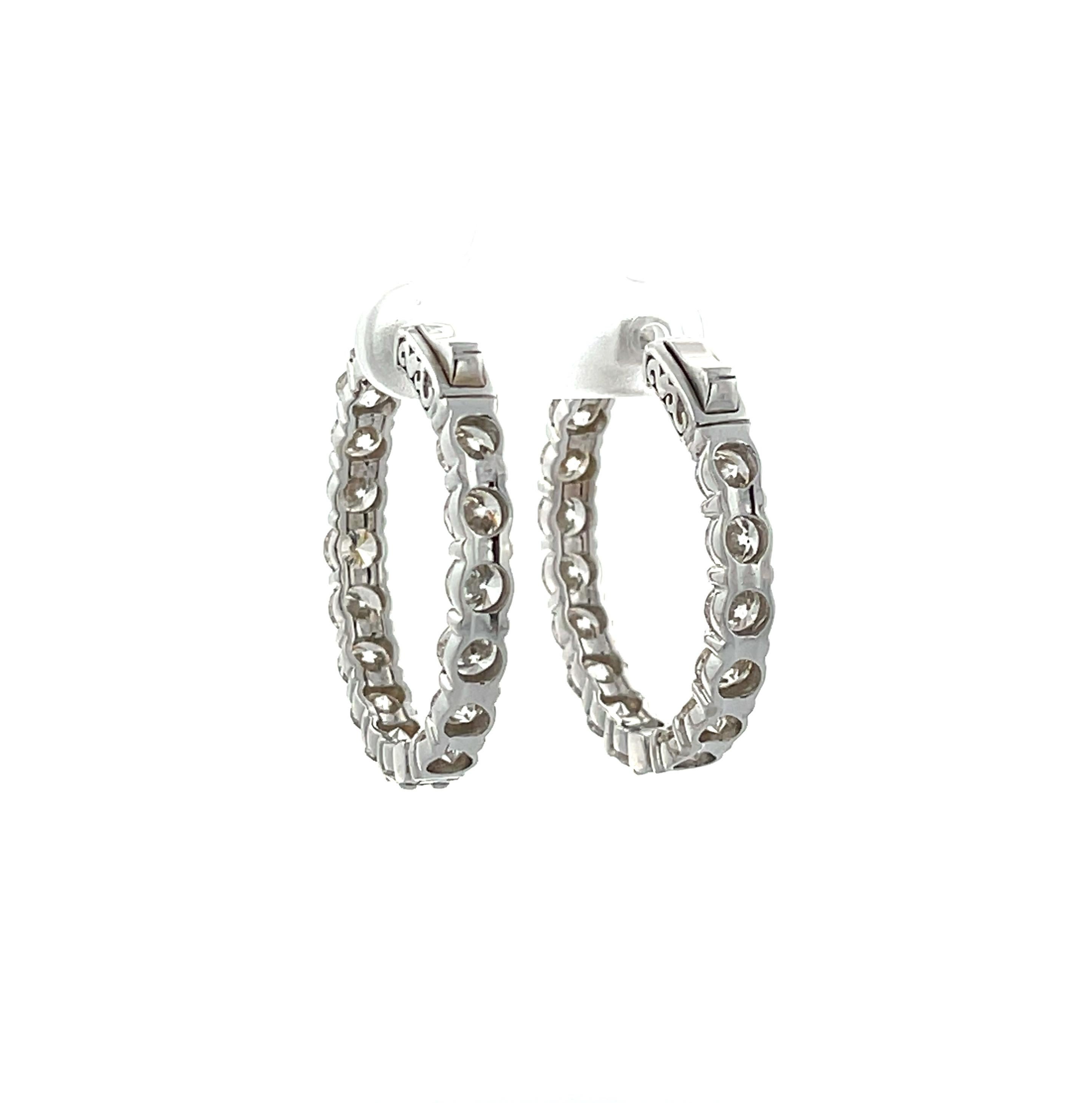 Make a statement with these absolutely beautiful hoop earrings! 
These timeless classics are set in 14 Karat White Gold with Sixteen (16) Round Brilliant Cut Natural Diamonds Weighing 9.81ctw all I-J/SI in Quality. 
The diameter sits at