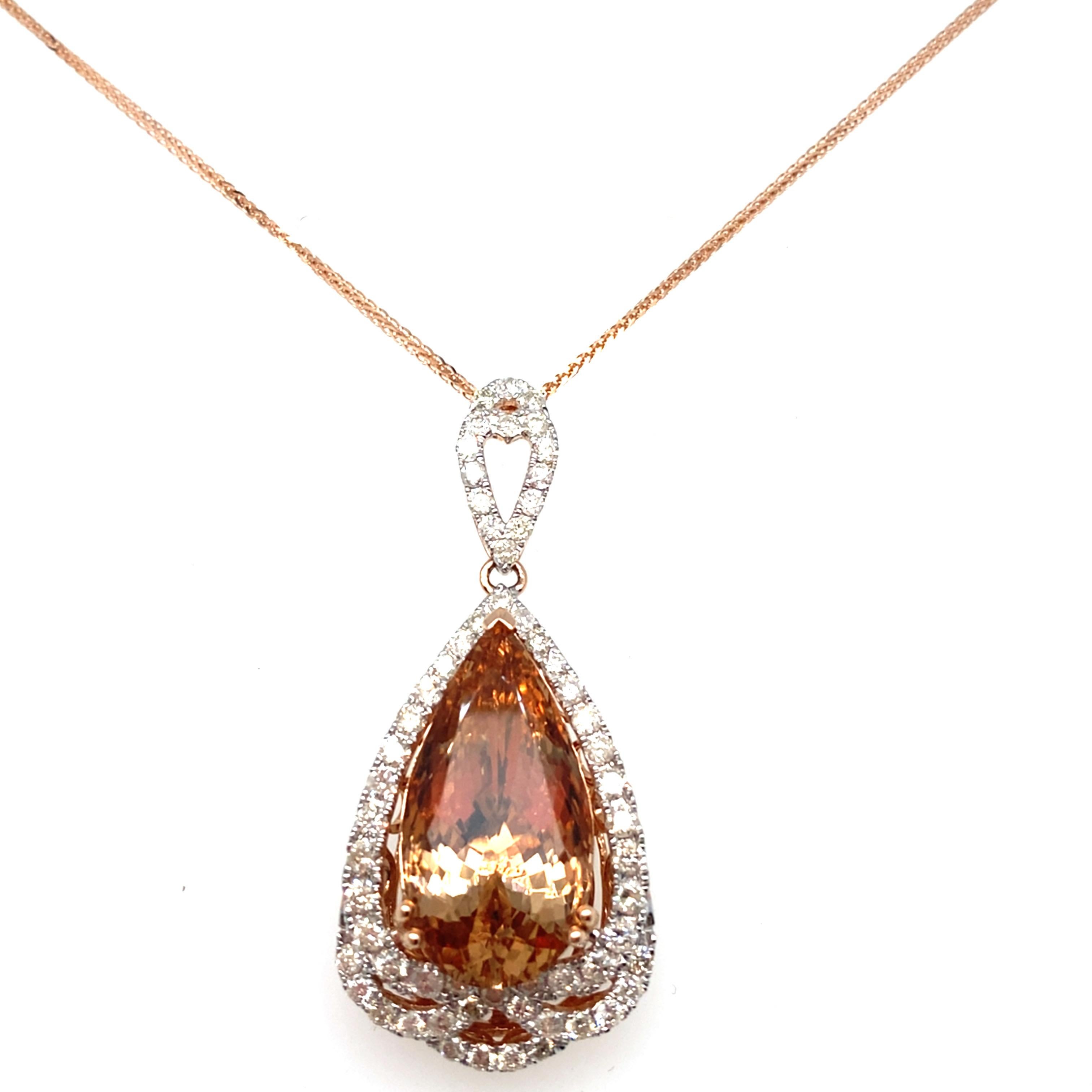 This exquisite morganite diamond pendant is elegantly crafted with a 9.82 carat pear-shaped morganite and 1.07 carat of diamonds, set in lustrous 14k rose gold. The pendant features a beautifully detailed back gallery, adding to its allure. This