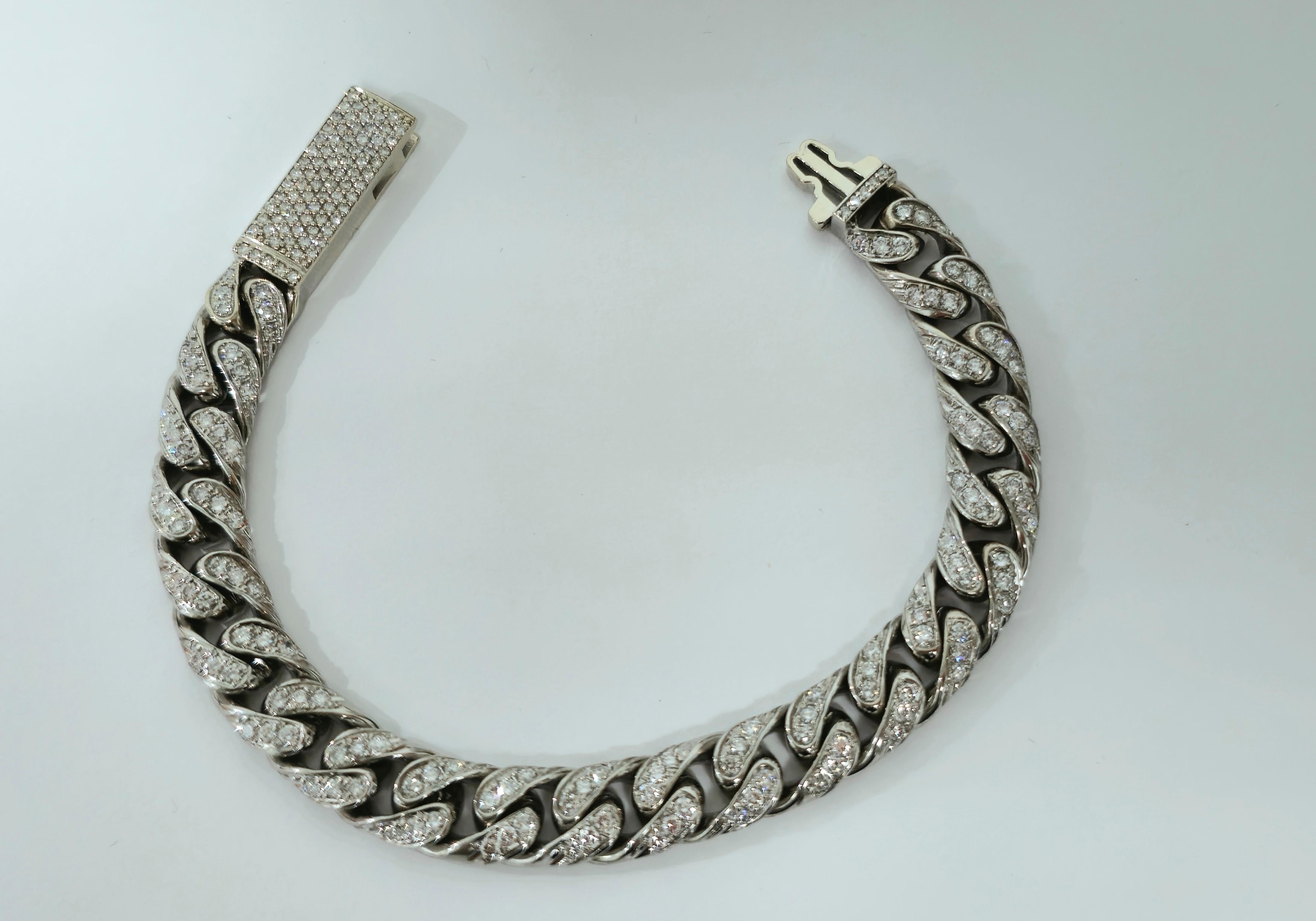 Handcrafted from lavish 18k white gold, this stunning cuban link bracelet boasts a total of 9.82 carats of natural earth mined diamonds, each exhibiting impeccable VS clarity and G color. The round brilliant-cut diamonds are meticulously set,