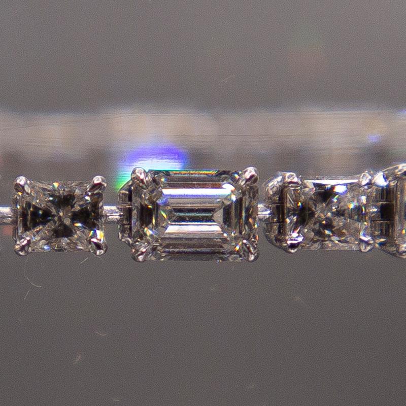 A one of a kind, 9.84 carats diamond 18k white gold bracelet with hand-selected, collection color F, Emerald and Princess cut diamonds averaging VS clarity. The meticulous matching of this spectacular suite of diamonds is accomplished by measuring