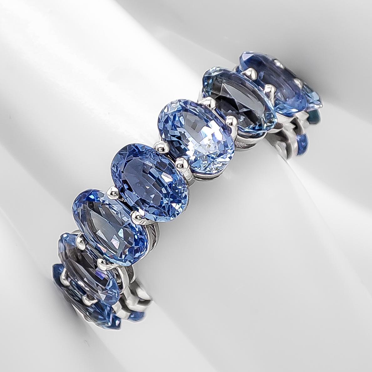 FOR US BUYERS NO VAT

Embrace a world of enchantment with this 14K white gold eternity ring featuring a dazzling array of 16 sapphires totaling 9.85 carats. The sapphires, ranging from light to medium blue, create a captivating spectrum of color,