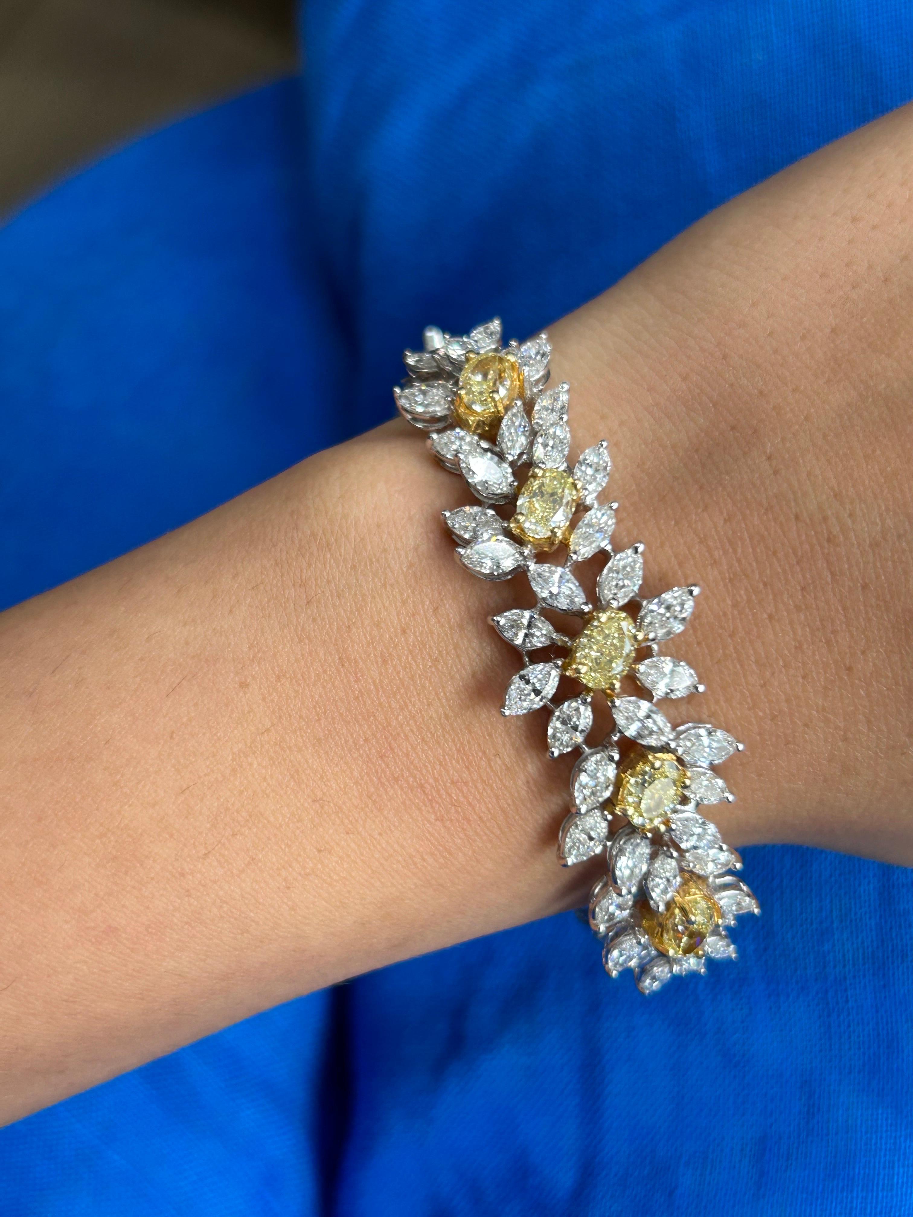 A total of 9.85 carat Yellow and White Diamond bangle, set in 18K White and Yellow Gold. The 5 center oval VVS/VS quality Yellow Diamonds weigh a total of 3.66 carats (average of 0.73 carats), adorned with 6.19 carats of 0.2/0.15/0.1 carat each