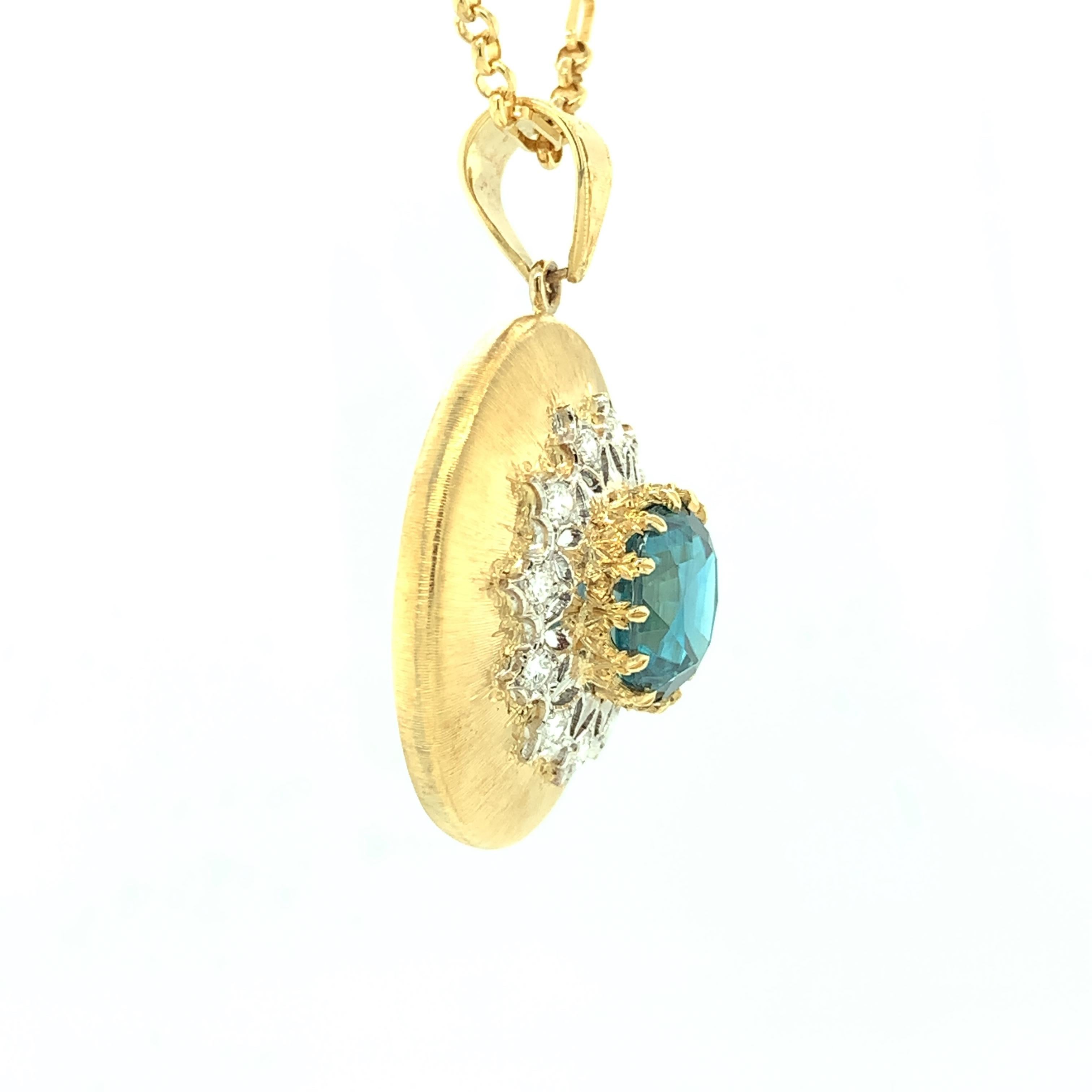 Elegance is the first word that comes to mind when looking at this gorgeous blue zircon and diamond pendant. A round, vivid blue zircon sits front and center, surrounded by brilliant cut white diamonds in this Florentine inspired piece. Handmade in