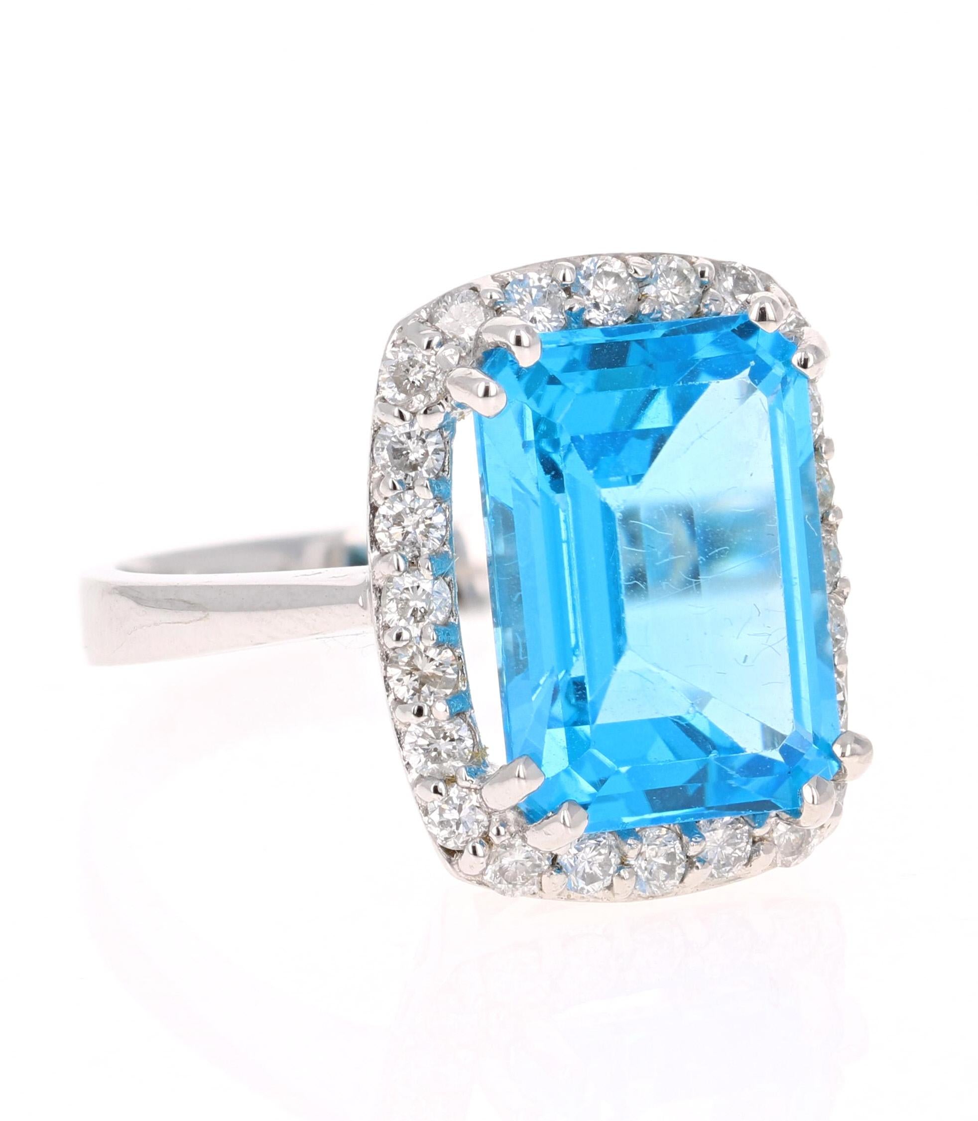 This beautiful Emerald cut Blue Topaz and Diamond ring has a stunningly large Blue Topaz that weighs 9.14 Carats. It is surrounded by 24 Round Cut Diamonds that weigh 0.74 Carats. The total carat weight of the ring is 9.88 Carats.   

The Blue