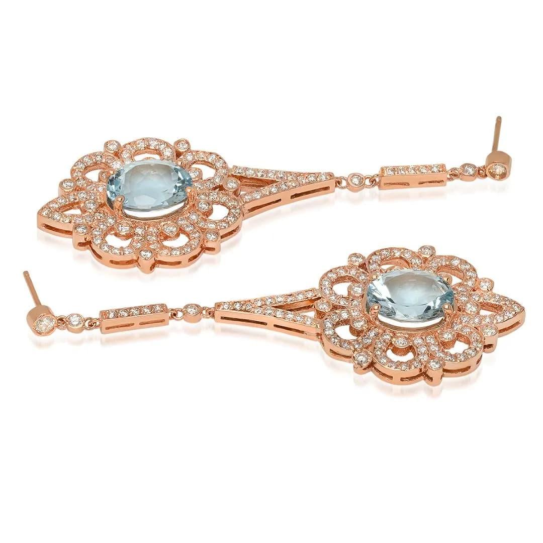 9.90Ct Natural Aquamarine and Diamond 14K Solid Rose Gold Earrings

Total Natural Oval Blue Aquamarines Weight is: Approx. 7.40 Carats

Aquamarine Measure: 10 x 8mm

Total Natural Round Cut White Diamonds Weight: Approx. 2.50 Carats (color G-H /