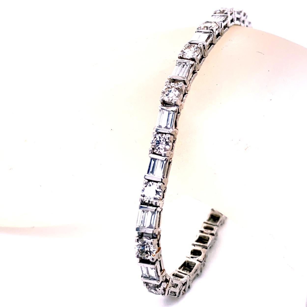 This beautiful Diamond Tennis Bracelet consists of 20 Links of alternating Round and Baguette diamonds set in platinum. The bracelet comes with a built-in hidden safety lock. 
Total Weight of diamonds: 9.91 Ct
Total Weight of bracelet: 20.20 gr
