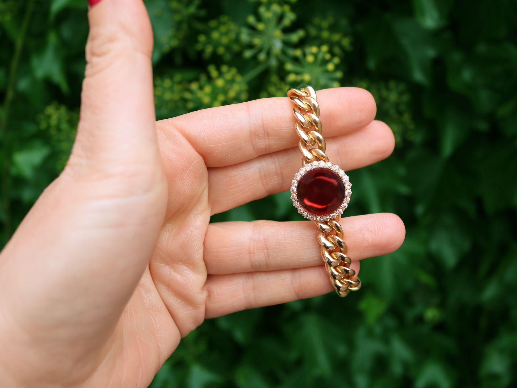 A stunning, fine and impressive antique Victorian 9.92 carat garnet and 1.07 carat diamond, 14 karat yellow gold bracelet; part of our bangle and bracelet collection.

This stunning antique cabochon cut bracelet has been crafted in 14k yellow