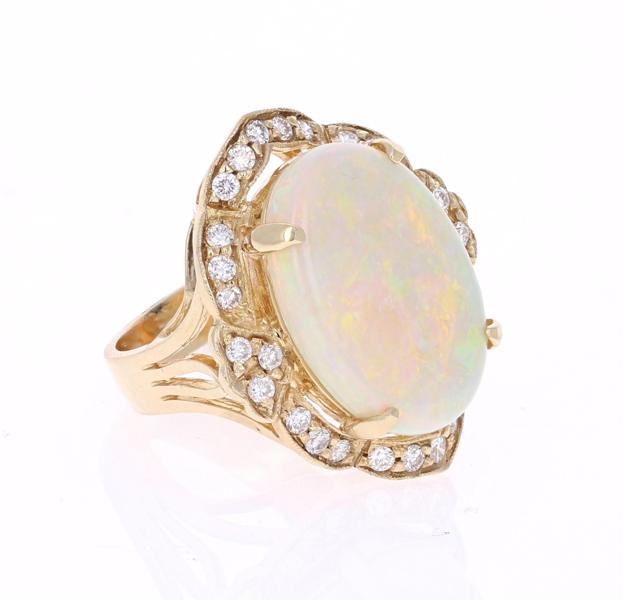 This ring has a 9.18 Carat Opal that is curated in a unique Victorian-Inspired setting 14 Karat Yellow Gold. The setting is adorned with 28 Round Cut Diamonds that weigh 0.84 Carats. The total carat weight of the ring is 9.93 Carats.

The Opal