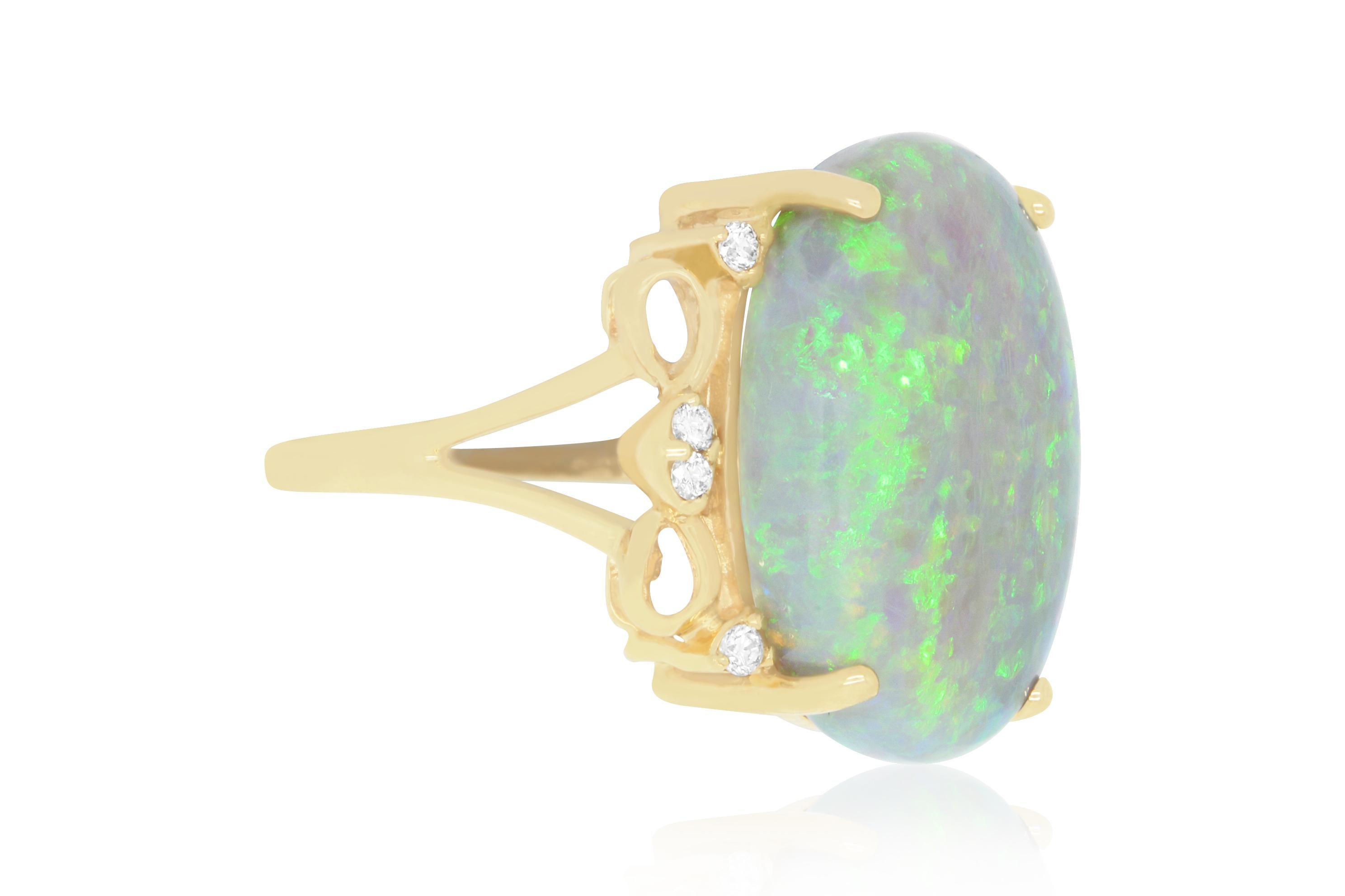 This beautiful 9.94 Carat Oval shaped Opal is complemented with swirls of 14K Yellow Gold and adorned with a Brilliant Round White Diamonds totaling 0.09 Carat for a clean and classy look.

Material: 14k Yellow Gold
Gemstone: 1 Oval Opal at 9.94