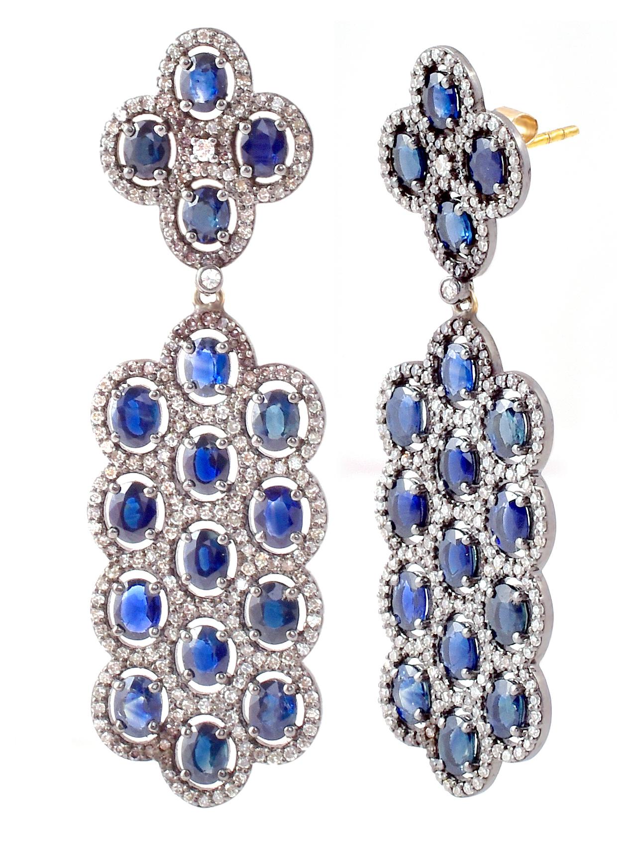 9.94 Carats Oval-Cut Blue Sapphires and Diamond Cluster Drop Earrings

This Victorian-era art-deco style elegant oxford blue sapphire and diamond cluster long hanging earring is spectacular. The three rows of matching oval blue sapphires are covered