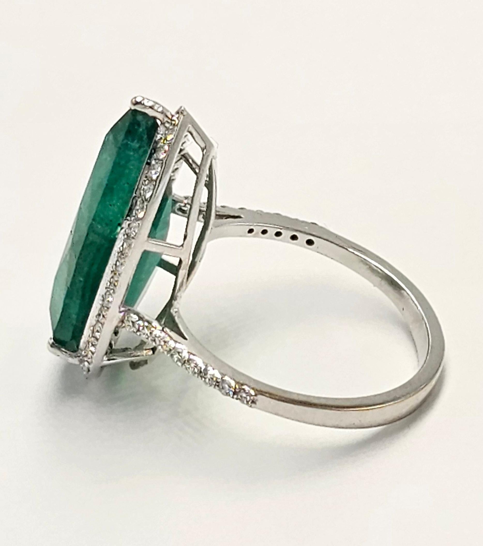 Set in a custom designed 18K white Gold ring, surrounded by beautiful and carefully curated diamonds this gorgeous pear shaped Emerald weighing 9.95 carats has a unique and rare combination of deep color, clarity and 5 plus carat size! The gemstone