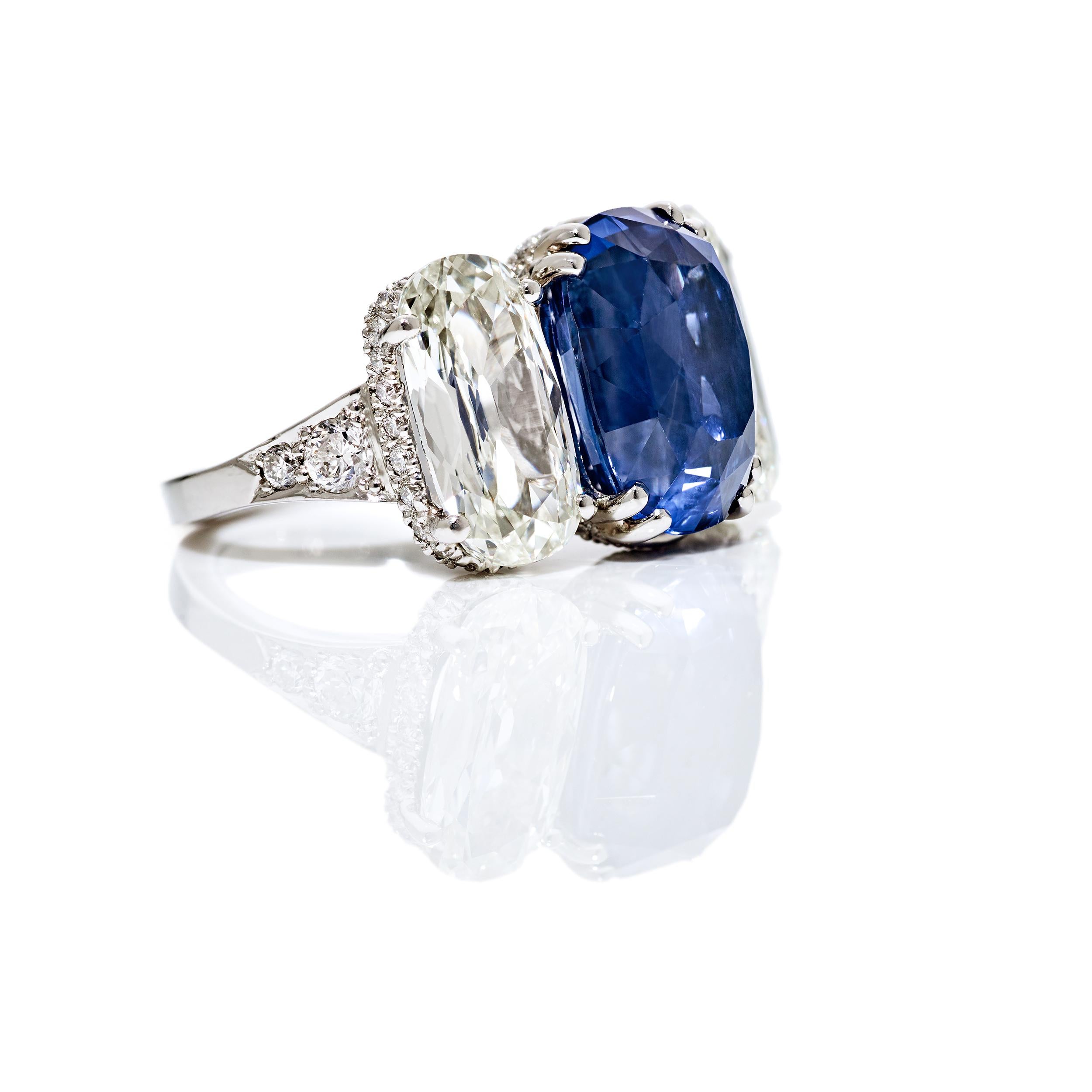 A one of a kind creation by Kiersten Elizabeth using a magnificent 9.98 Carat Elongated Cushion Cut Blue Sapphire center flanked by incredibly striking matched Elongated Cushion Cut Diamonds.  The measurements on these one of a kind gems is